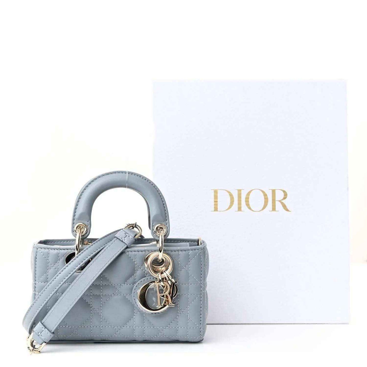 Micro handbag in cloud blue lambskin with cannage quilting, top handles and strap