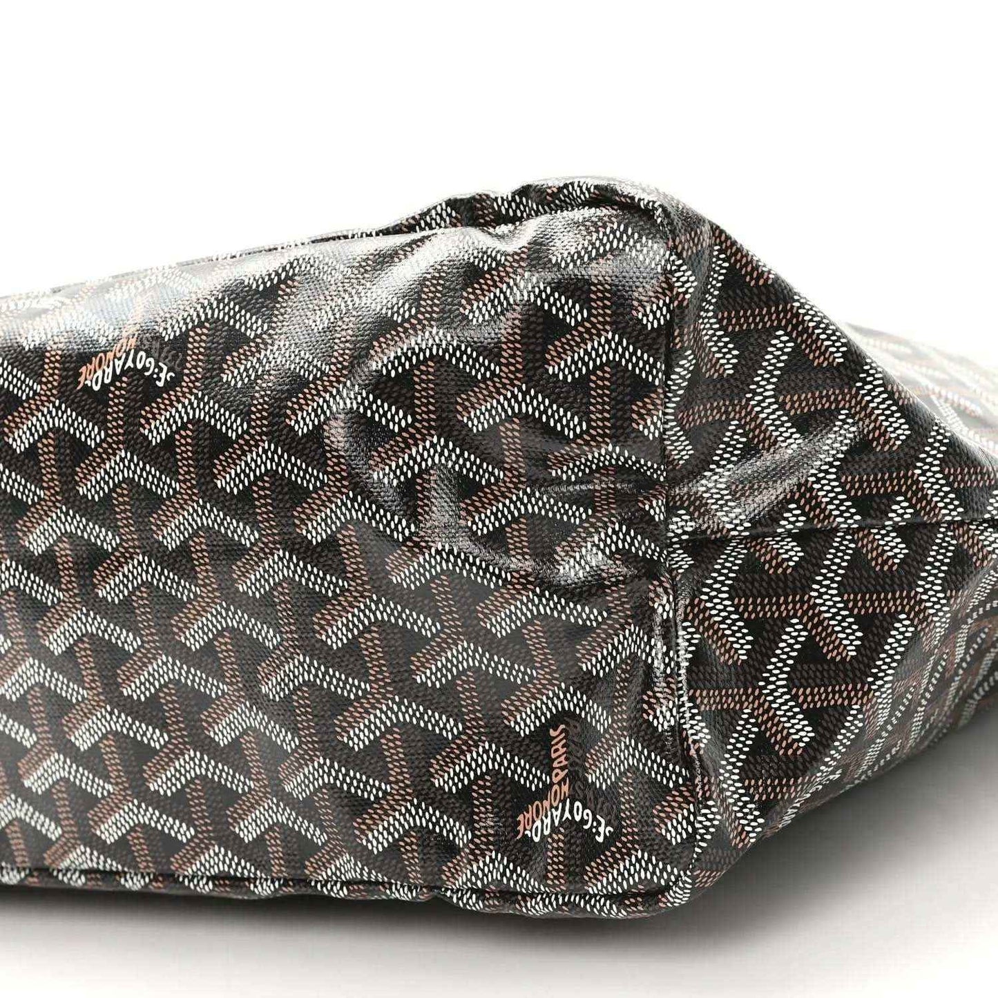 Black Goyard tote fabric with geometric pattern and stitched rolled top, close-up