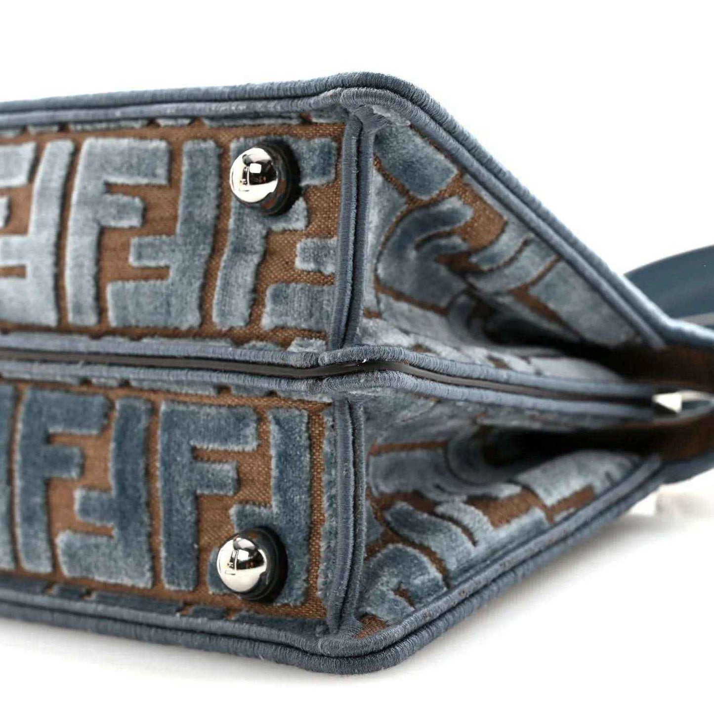 Satchel interior lining close-up with FF pattern, edge piping, and strap attachment