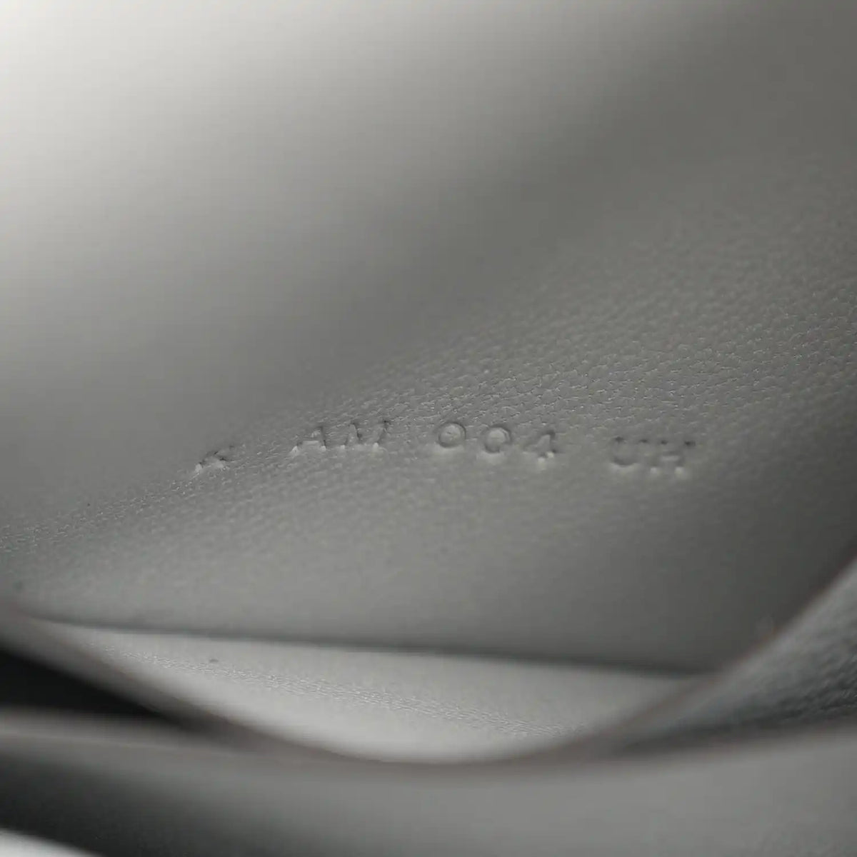 Hermes Constance slim wallet embossed markings on light blue leather interior.