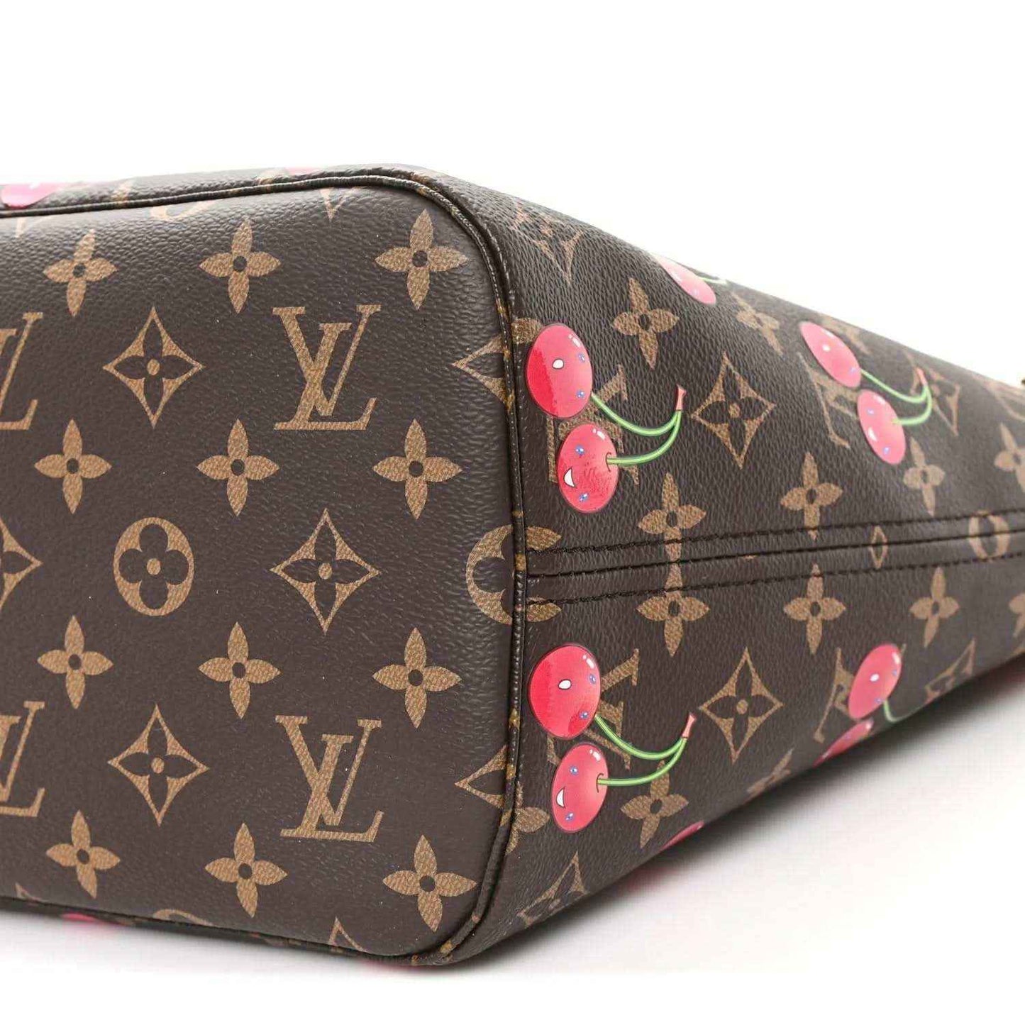 Monogram canvas tote bag side panel with cherry print and stitched seam lines.