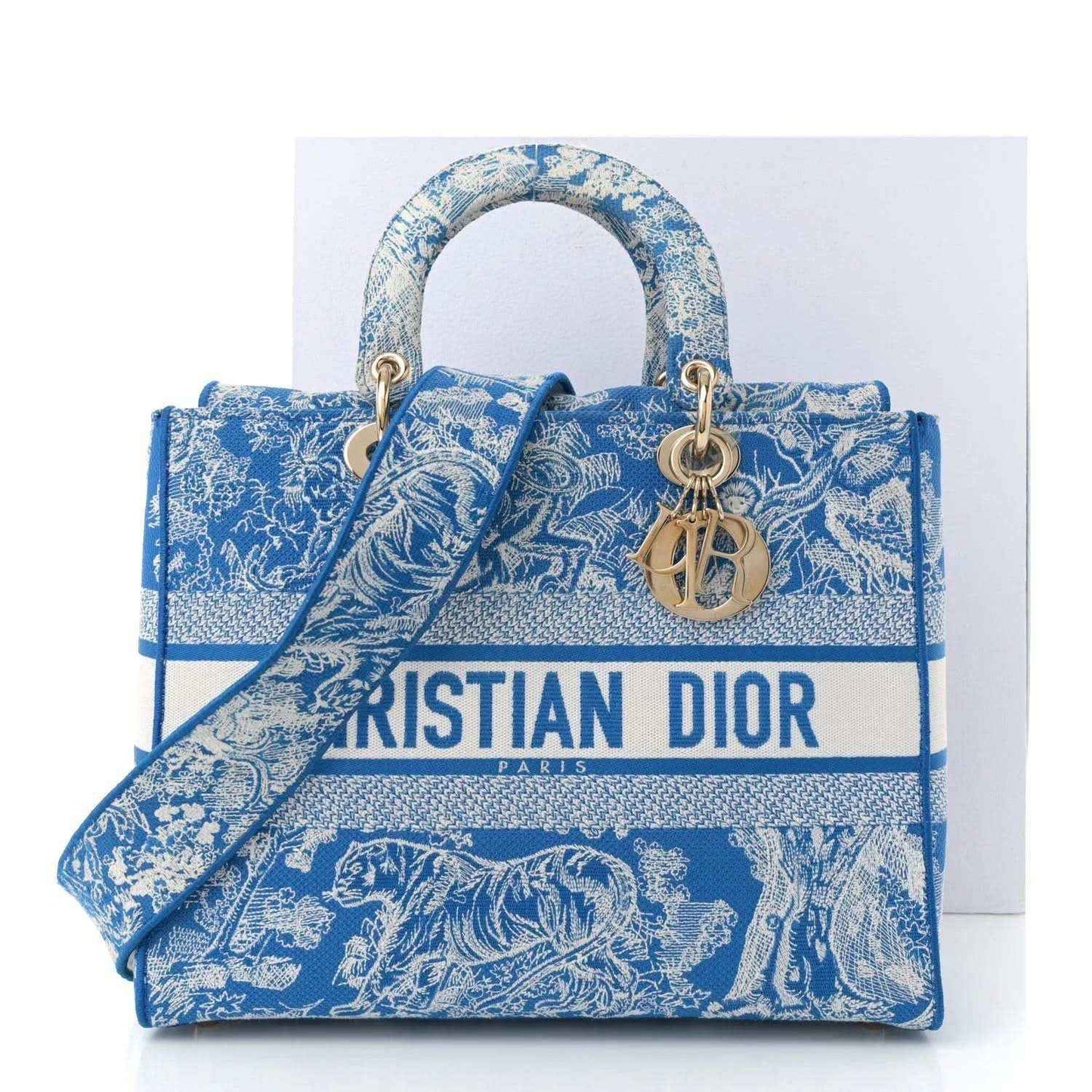Blue toile embroidered tote bag with gold-tone handles and CD charm