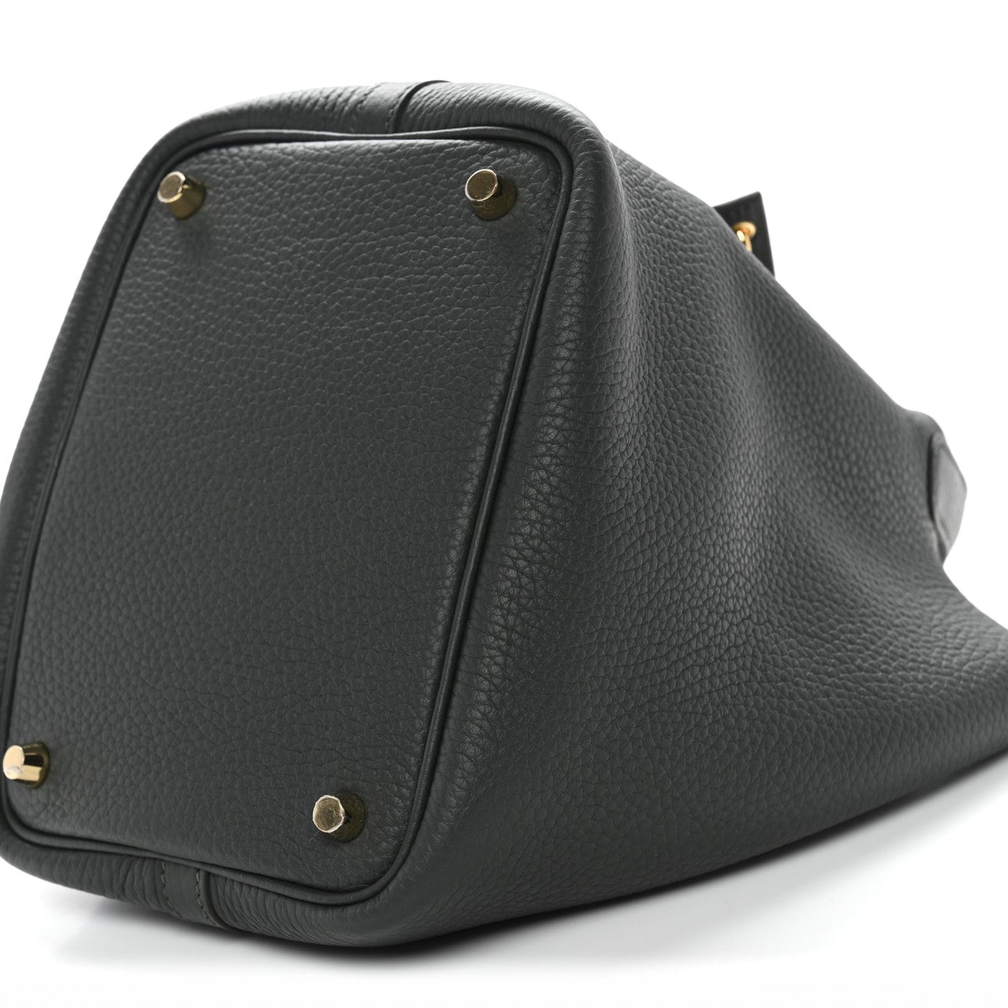 Triangular side view of dark green textured mini bag with gold-tone studs and flap.