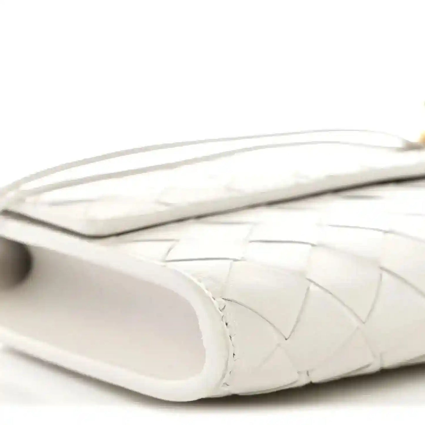 White nappa clutch side view with handle strap and open interior edge
