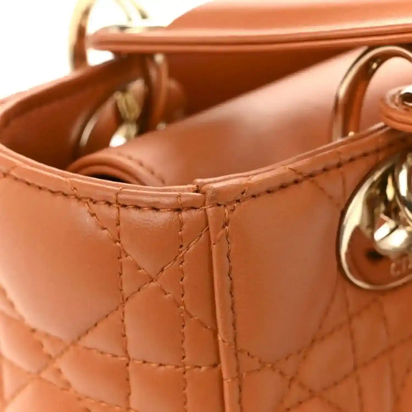 Small tote side with quilted orange lambskin panels and gold hardware ring