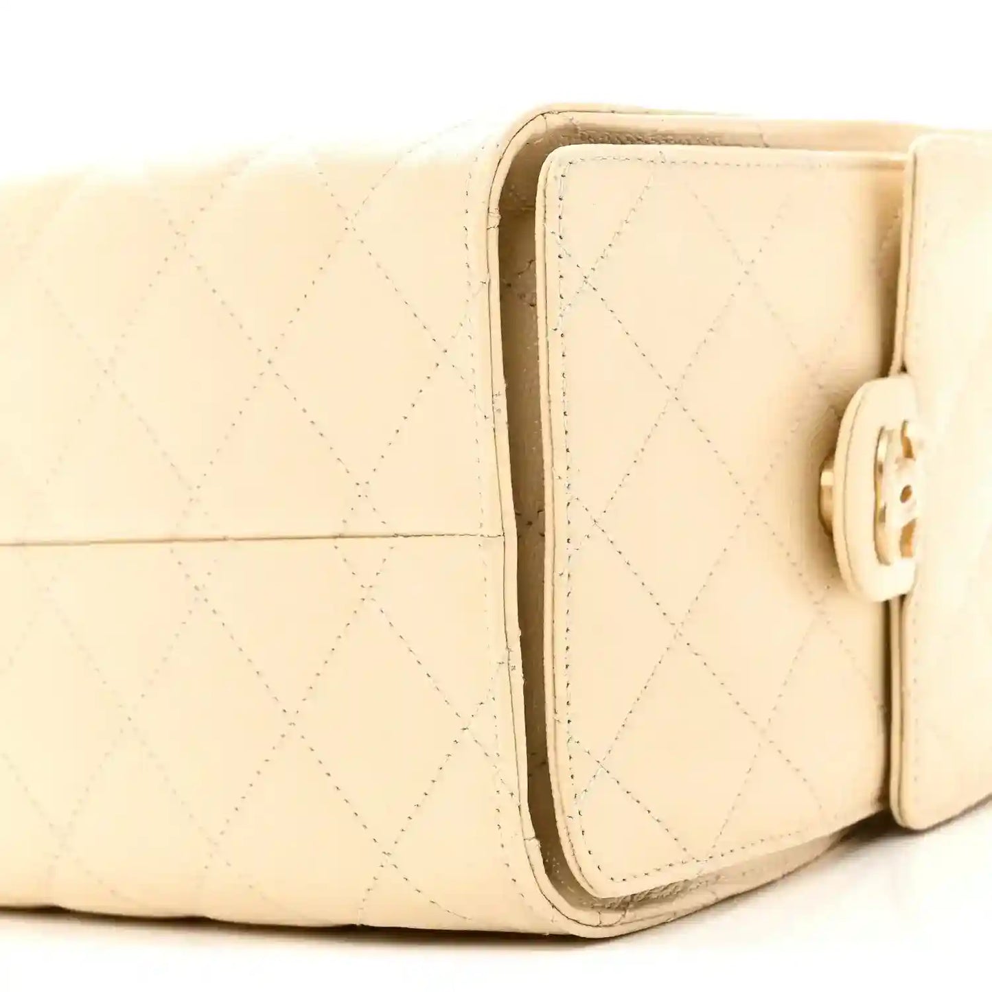 Light beige quilted handbag with front flap and gold-tone clasp closure