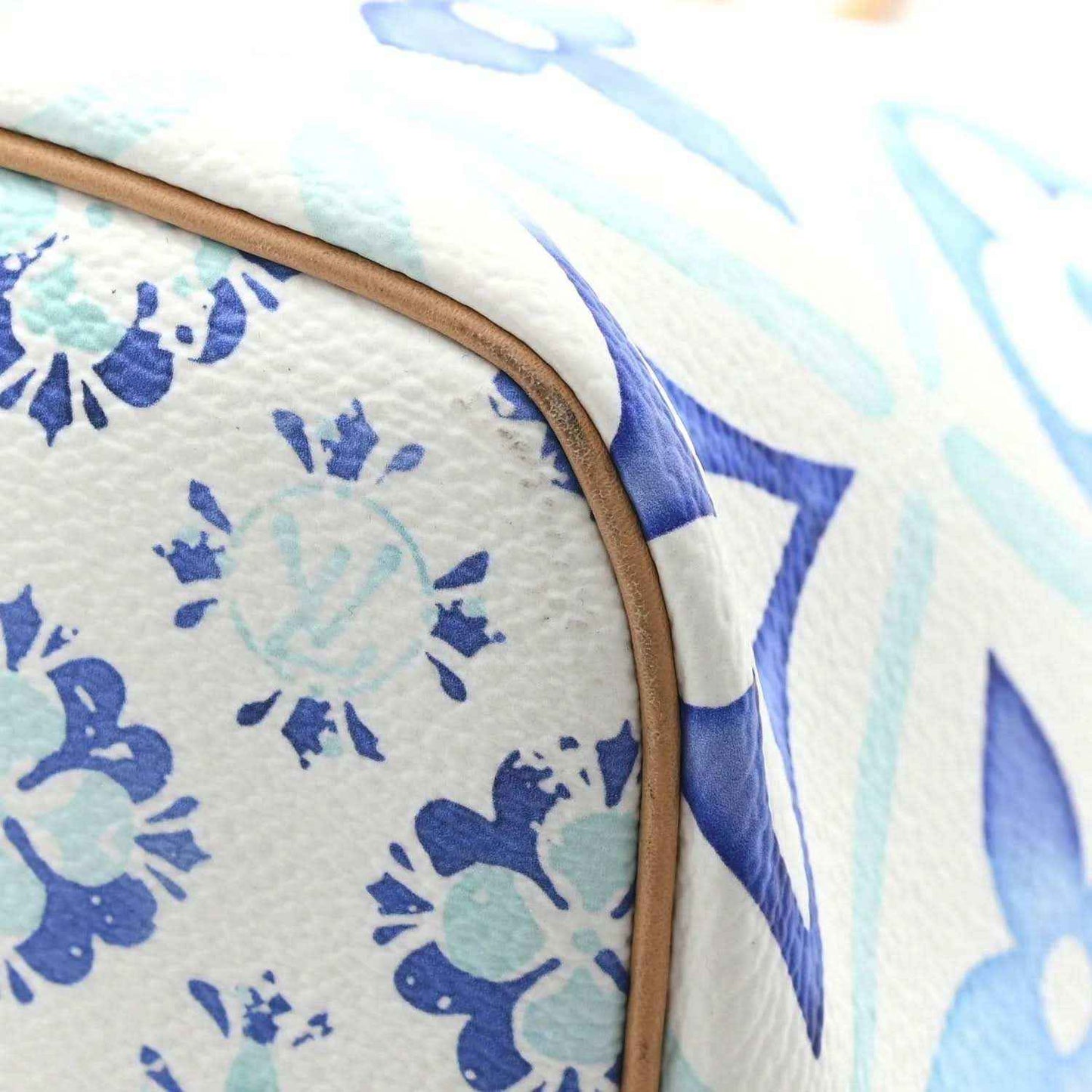 Blue and white monogram tote bag edge with tan leather trim and stitched seam
