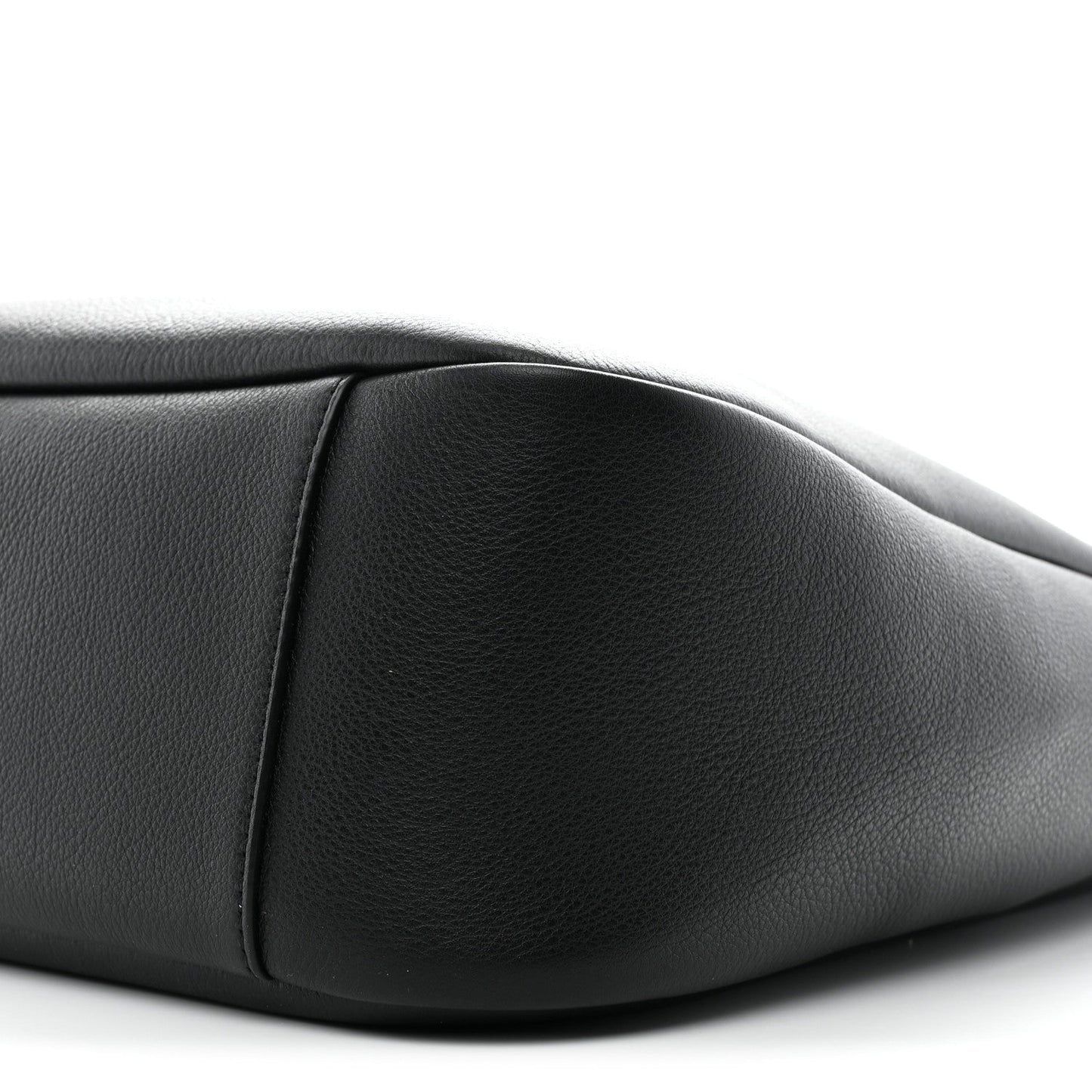 Black calfskin soft hobo bag close-up, showing curved seam and smooth texture