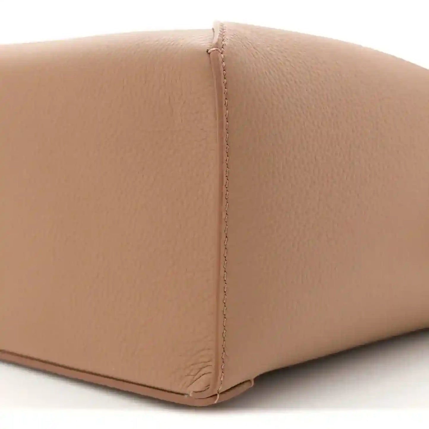 Toffee leather base edge with neat turn-stitching and grained texture
