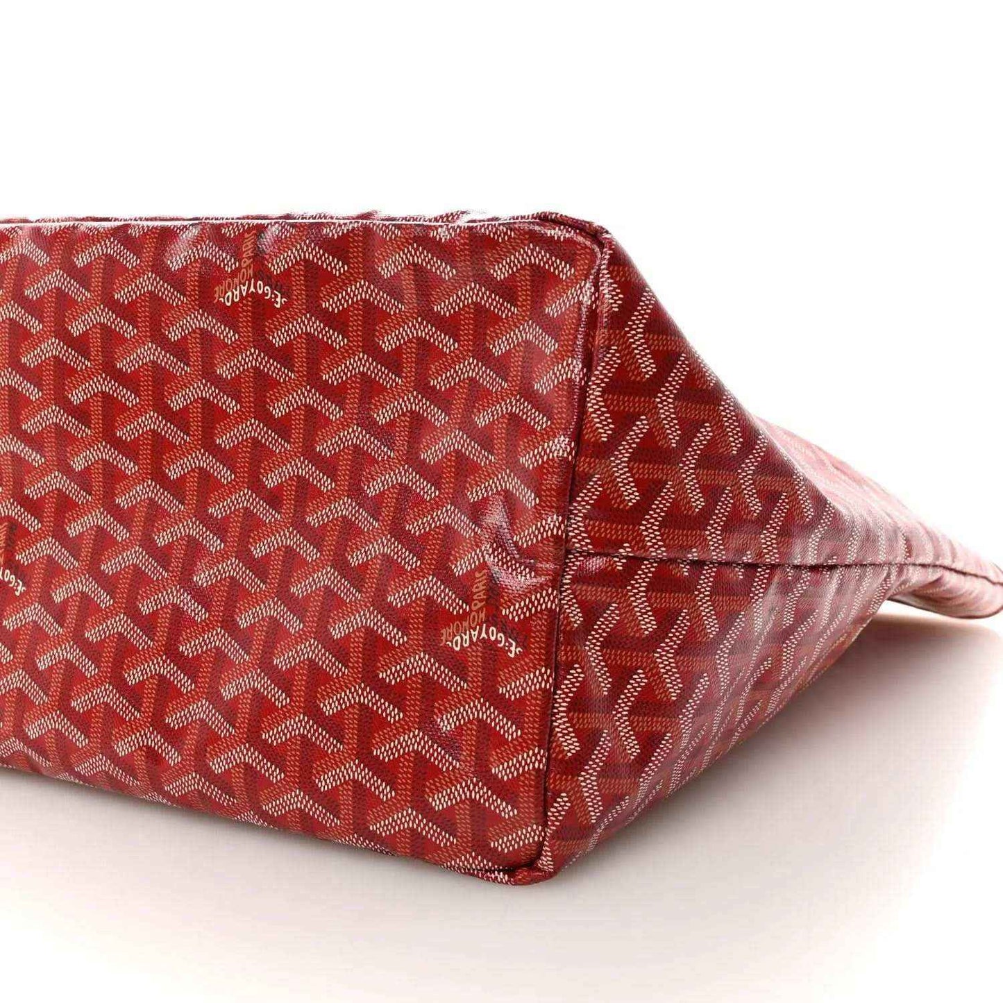Red Goyardine canvas tote bag side panel with Goyard pattern and corner seam.