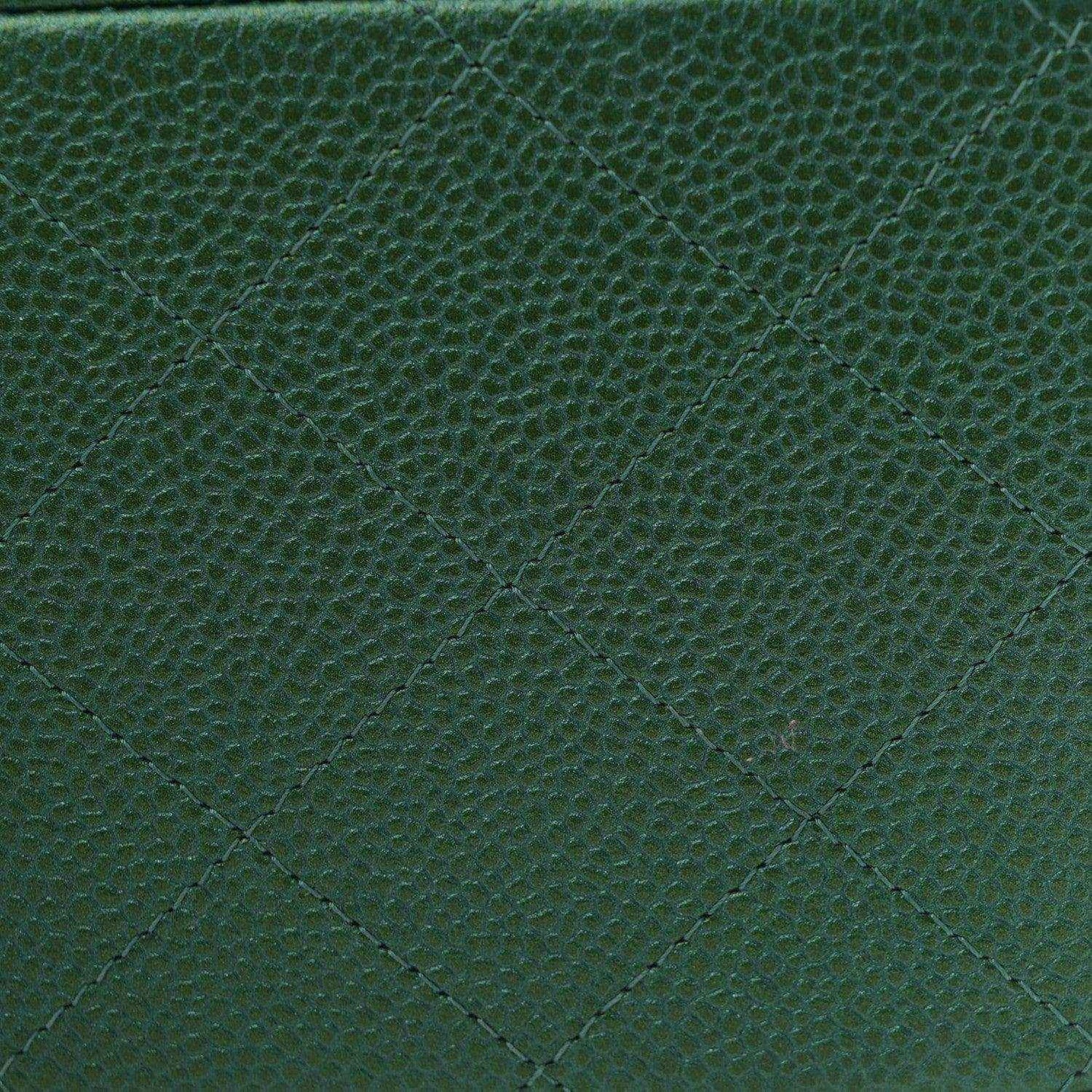 Green quilted caviar leather surface with diamond stitching texture.