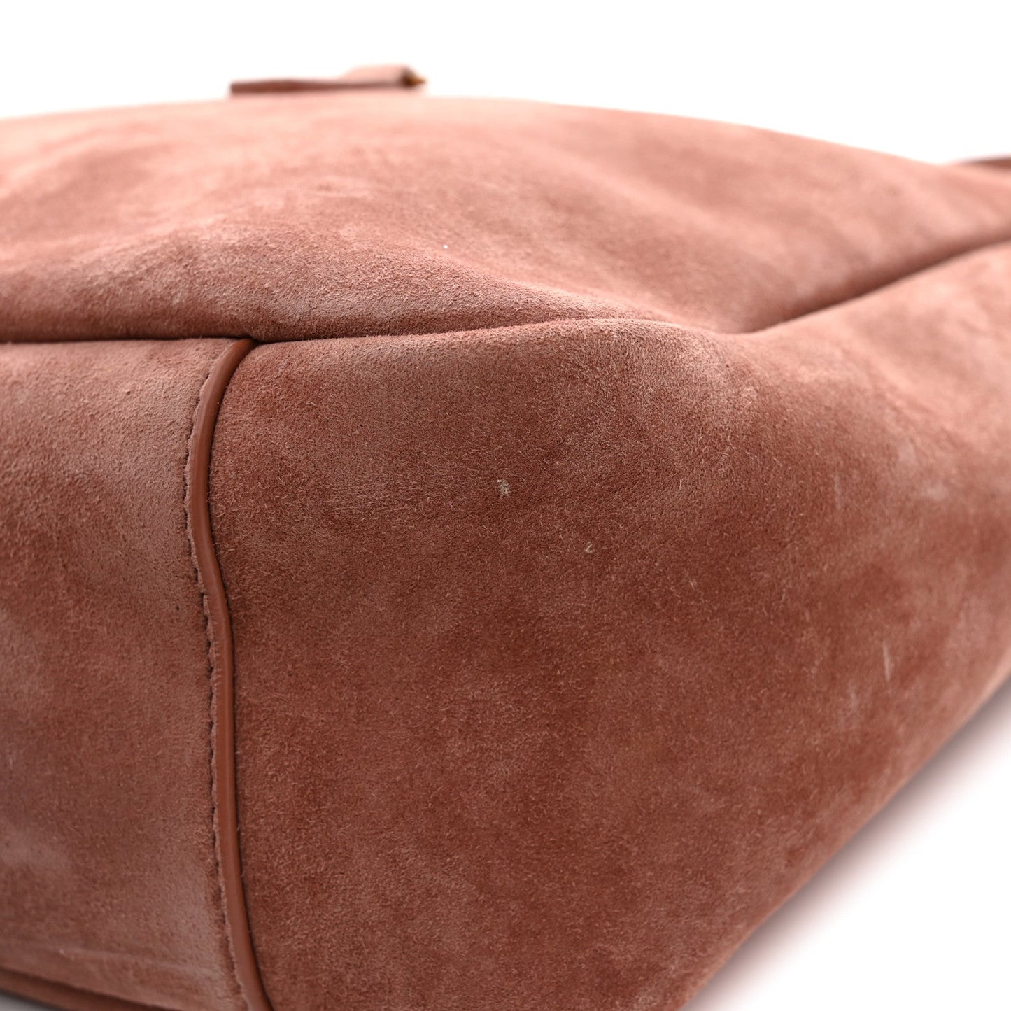 Suede hobo bag corner detail, barley pink calfskin with stitched edge