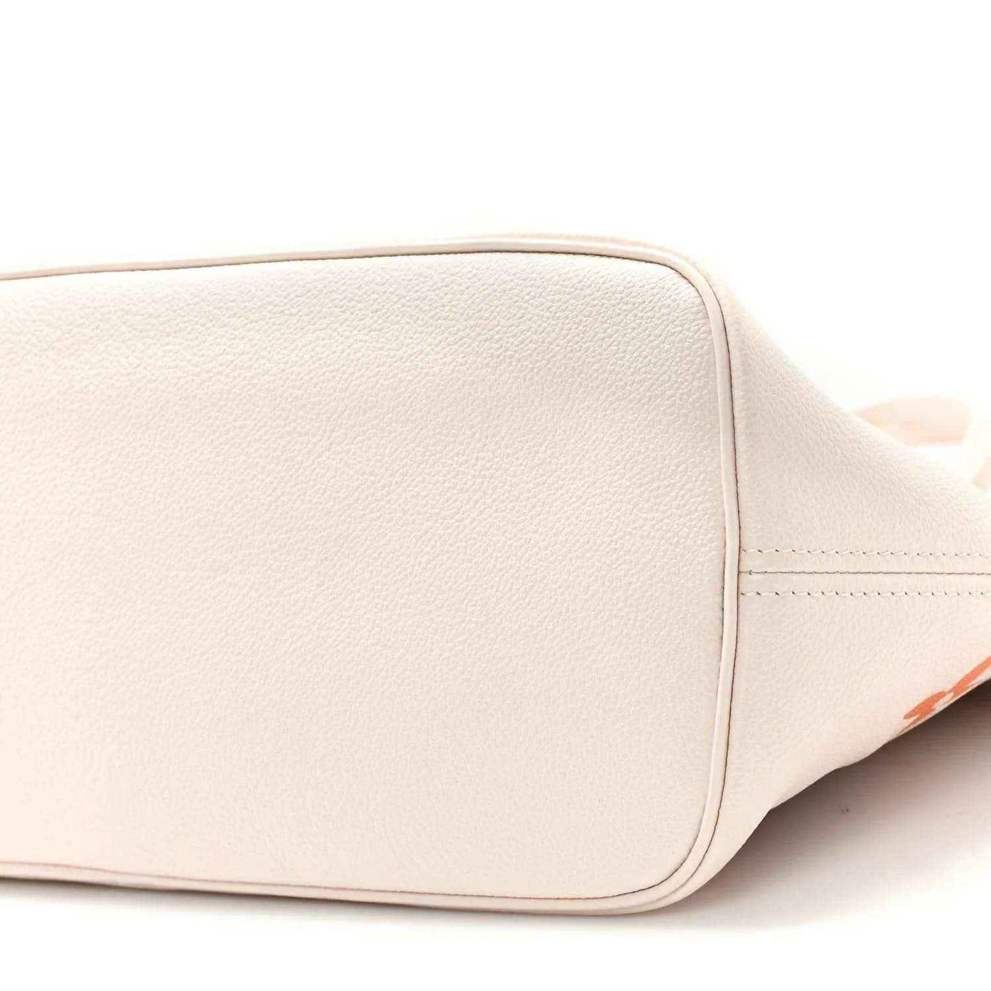 Neutral tote close-up of bottom corner with smooth leather panel and stitched edges
