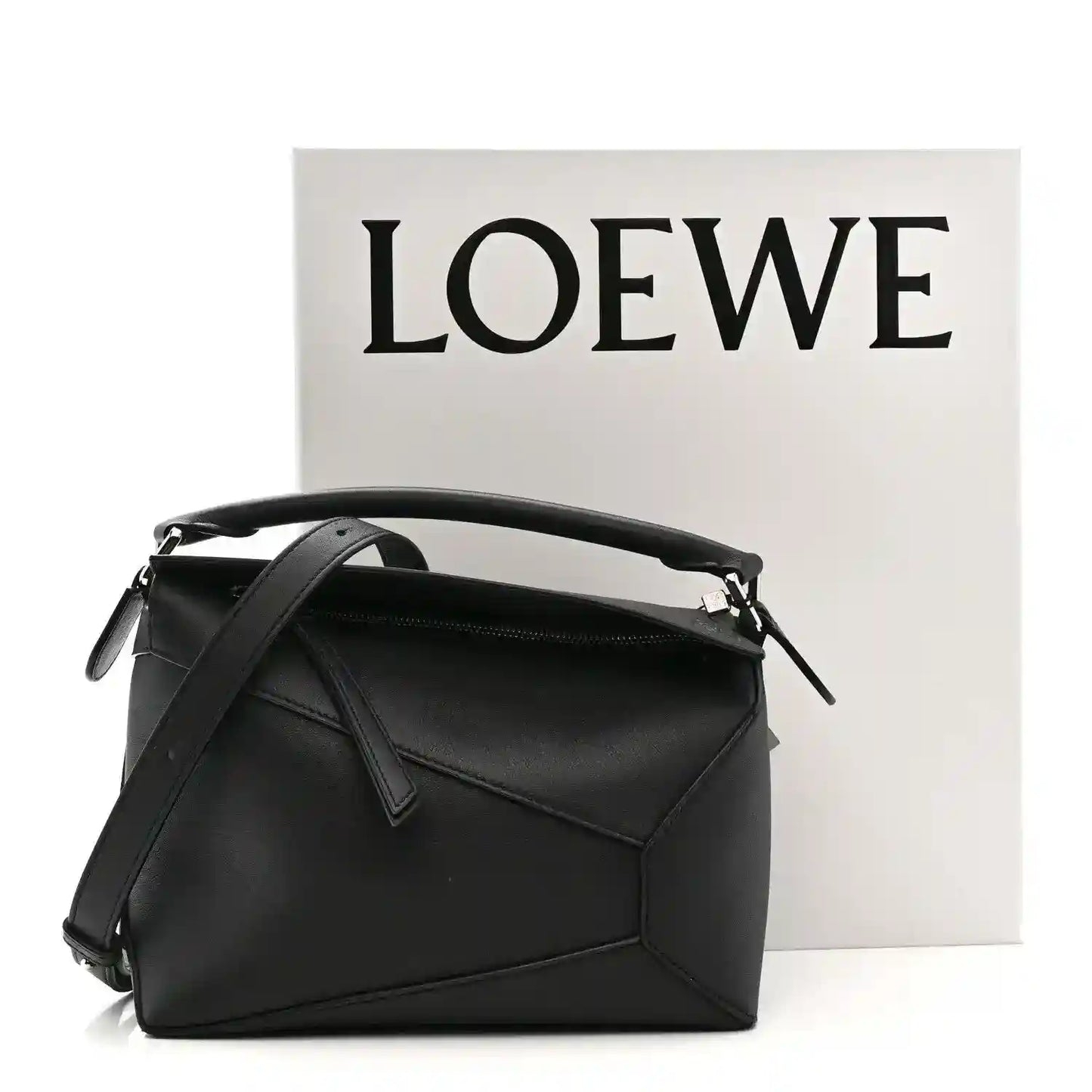 Small black calfskin shoulder bag with top handle, shoulder strap, and front flap