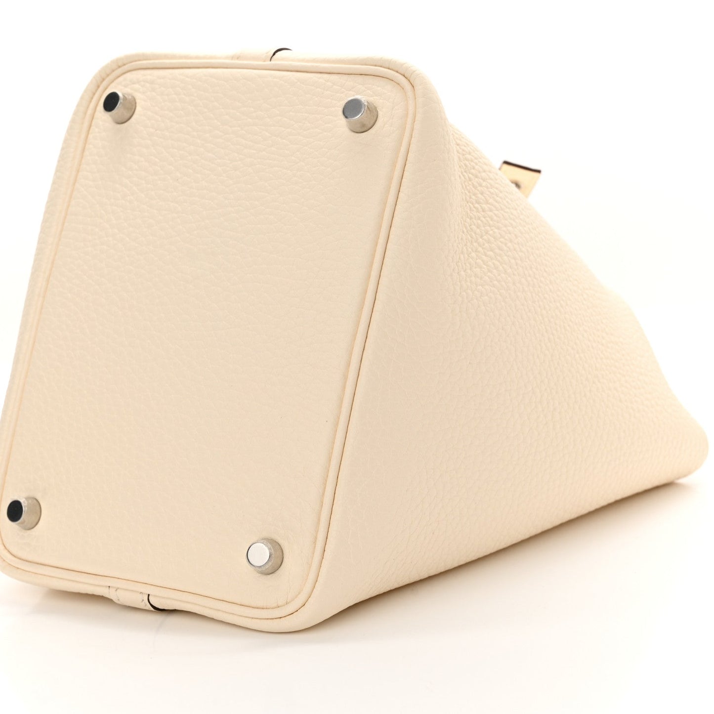 Nata leather handbag corner view with protective metal studs on structured base