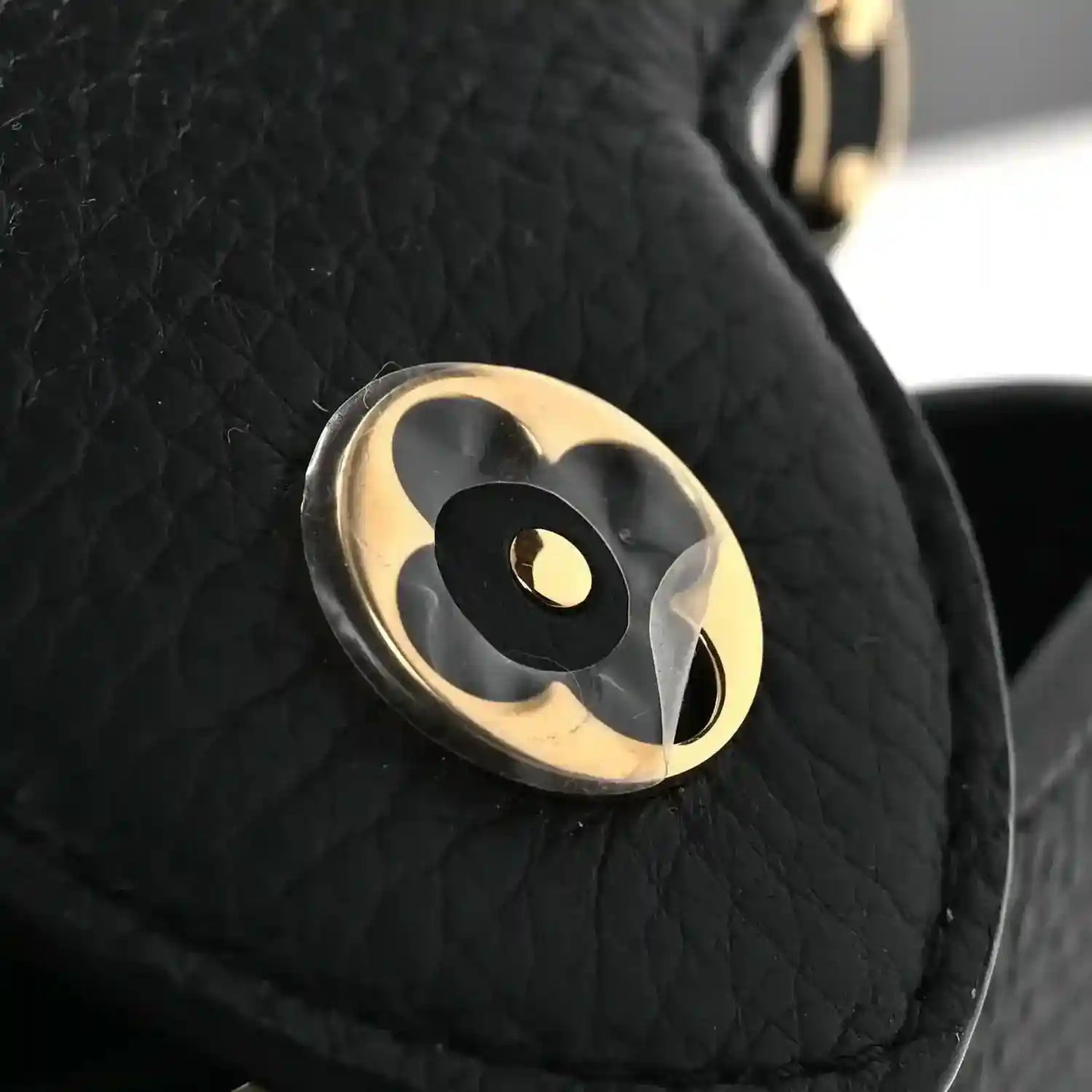 Black leather mini Capucines crossbody bag with gold-tone emblem logo