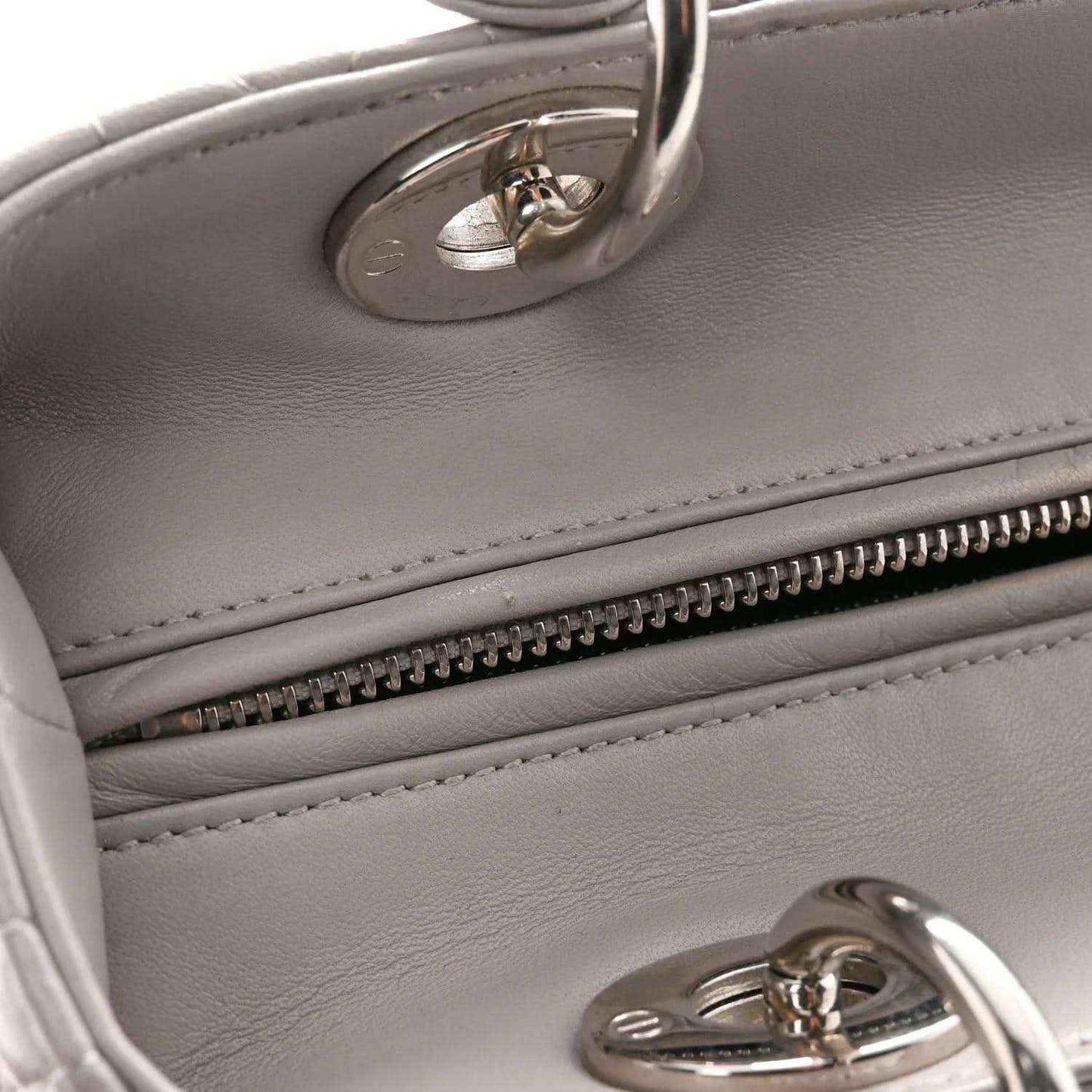 Grey leather handbag with interior zipper trim and silver hardware