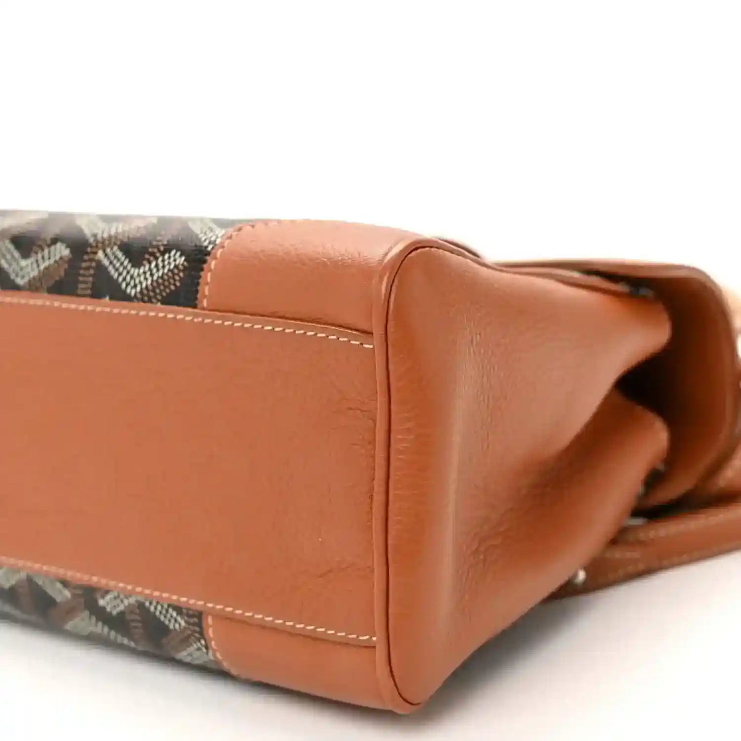 Mini Saigon bag side close-up, patterned canvas with brown leather edge and handle