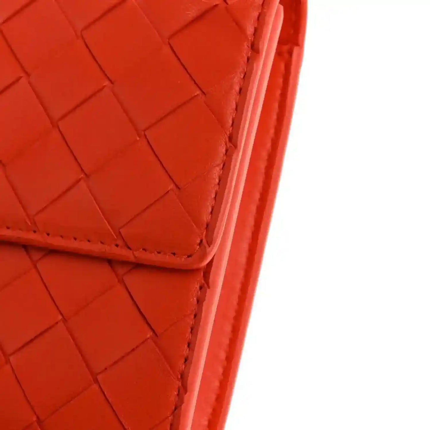 Orange intrecciato nappa clutch corner with stitched edge and structured seam