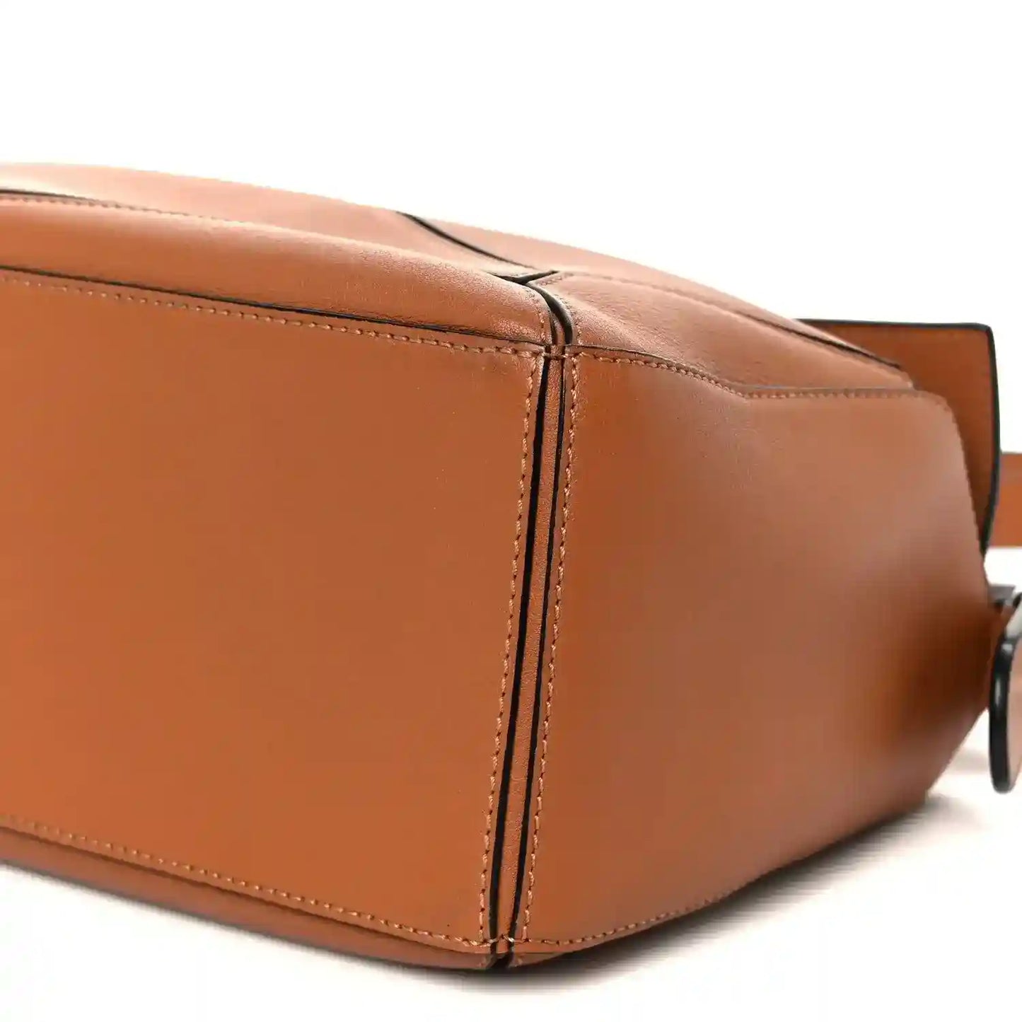 Tan calfskin small Puzzle shoulder bag, close-up of stitched panels and metal strap ring