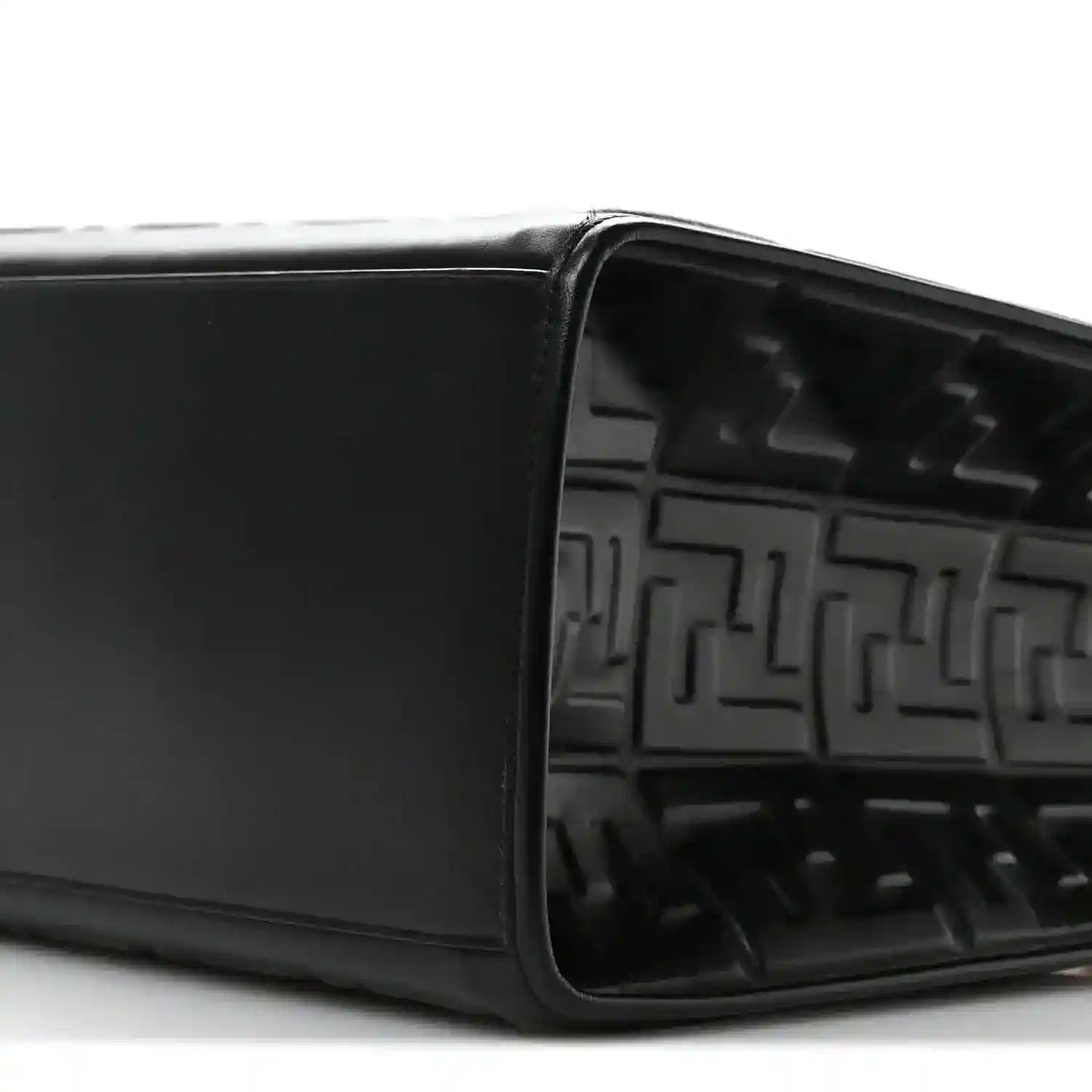 Black leather tote bag open top showing embossed FF pattern inside