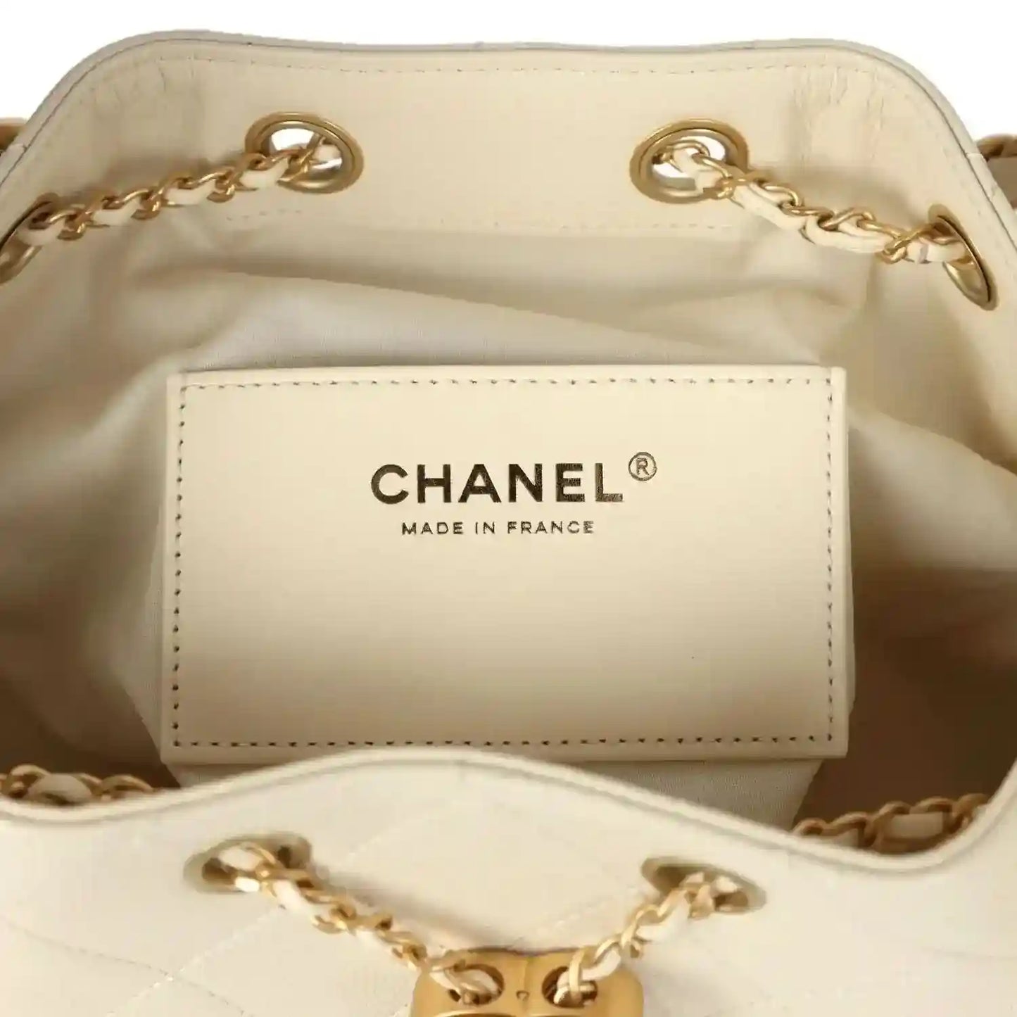 Chanel pocket label inside light beige hobo bag lining with gold-tone chain trim