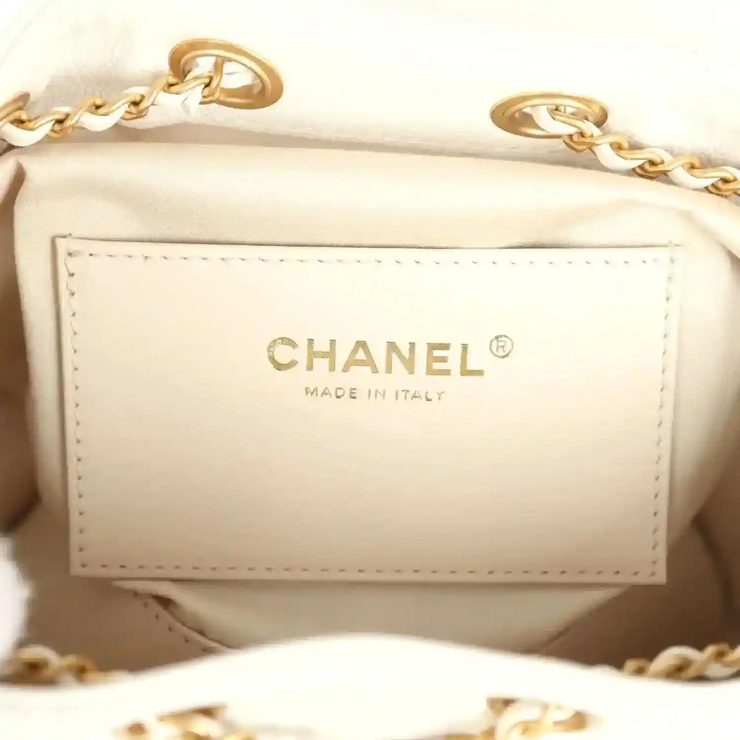 Mini hobo bag interior label reading CHANEL and MADE IN ITALY in gold-tone lettering