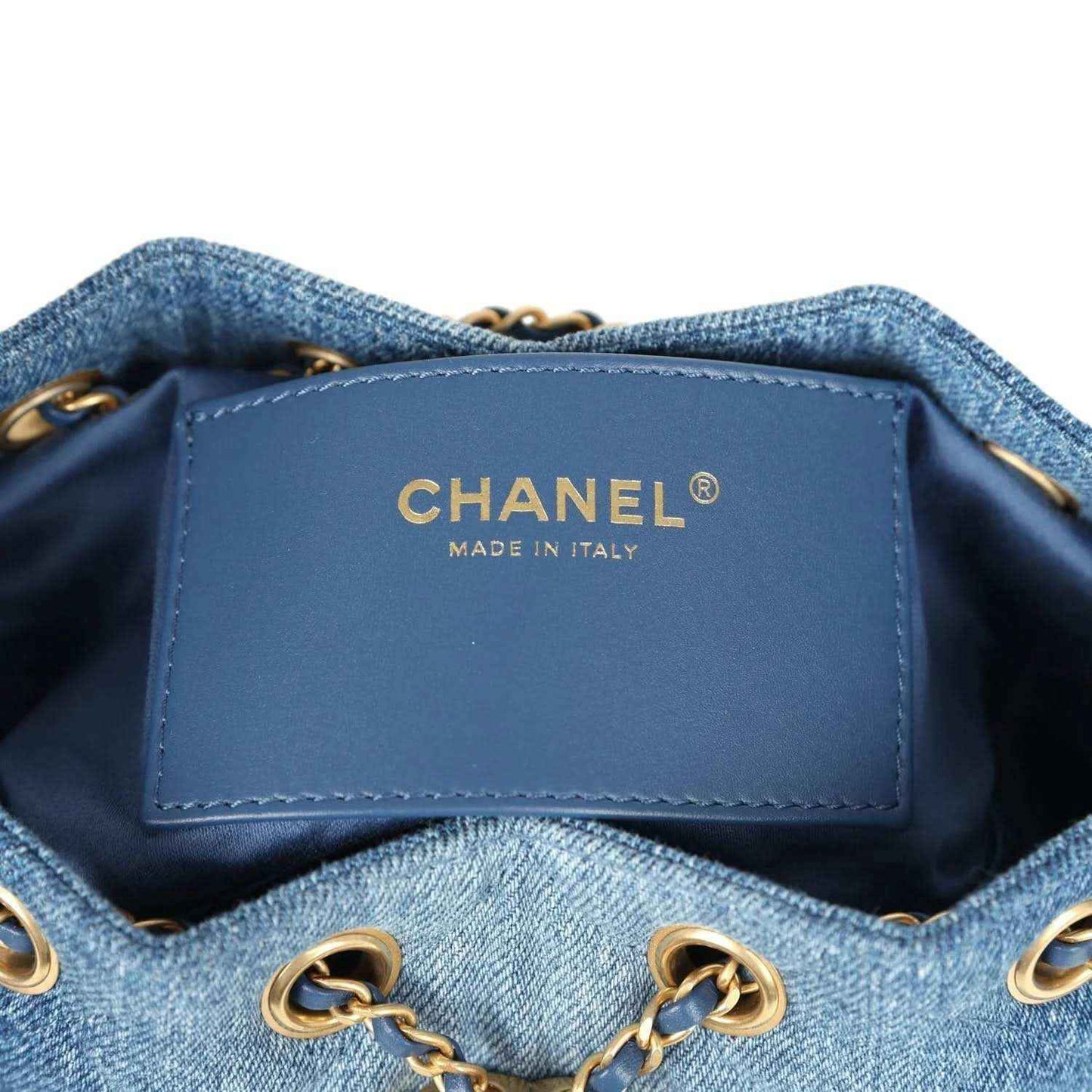Chanel interior label on blue denim mini hobo bag lining, with gold chain hardware at sides