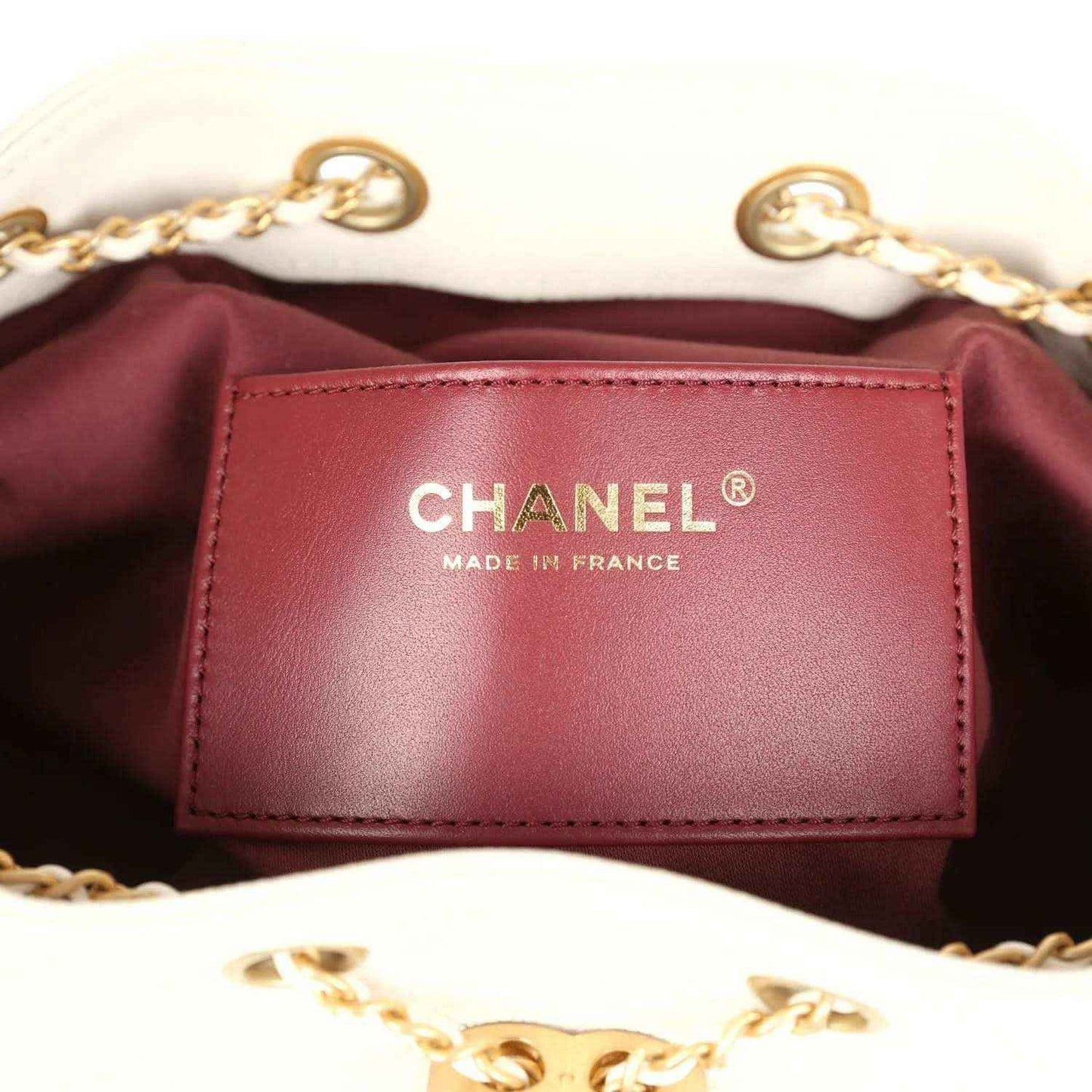 Chanel interior label patch reading CHANEL and MADE IN FRANCE on burgundy lining
