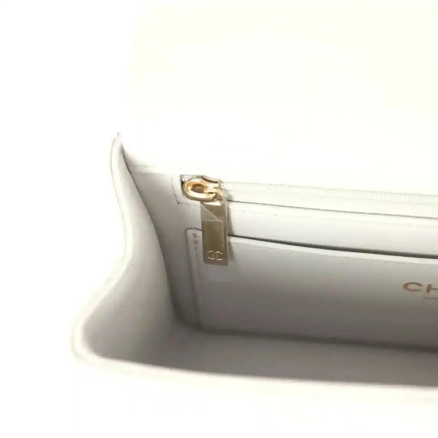 Chanel mini flap bag interior clasp hardware, gold-tone latch detail
