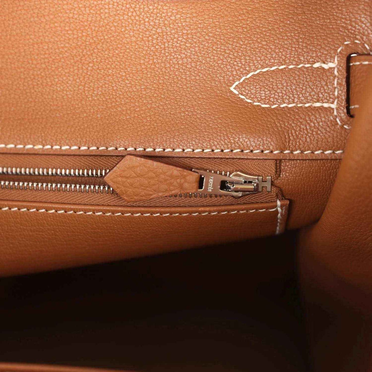 Hermes Birkin 30 handbag close-up of zipper track and leather tab with palladium hardware