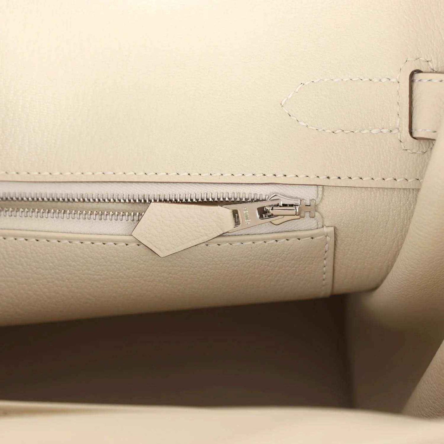 Birkin 30 handbag interior with light cream zip pocket and metal clasp hardware