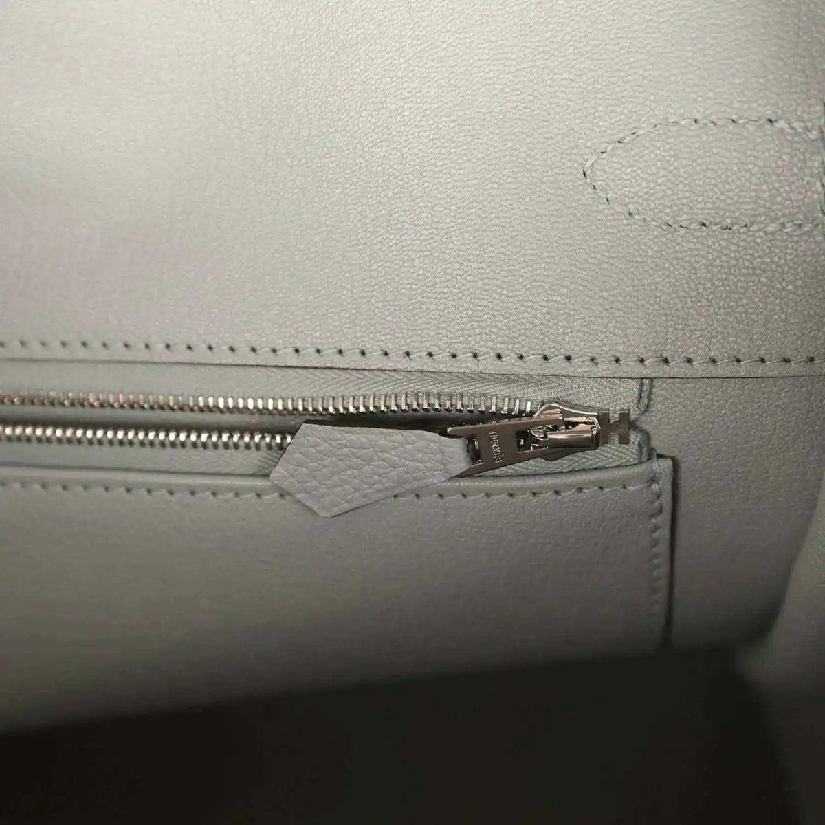 Birkin 35 handbag interior close-up of zipper pull and stitched trim