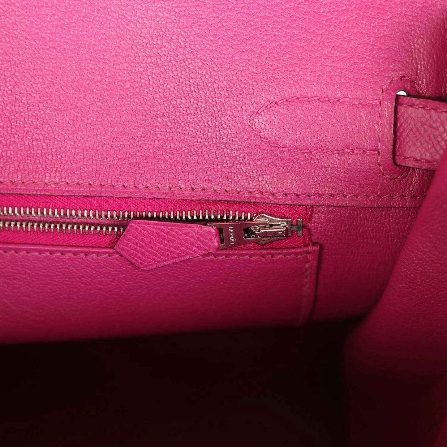 Rose-purple leather interior with zipper pull and small pocket detail
