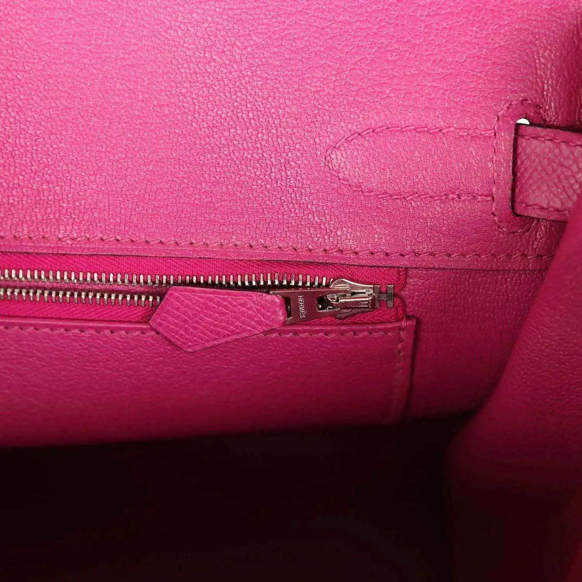 Rose-purple leather interior with zipper pull and small pocket detail