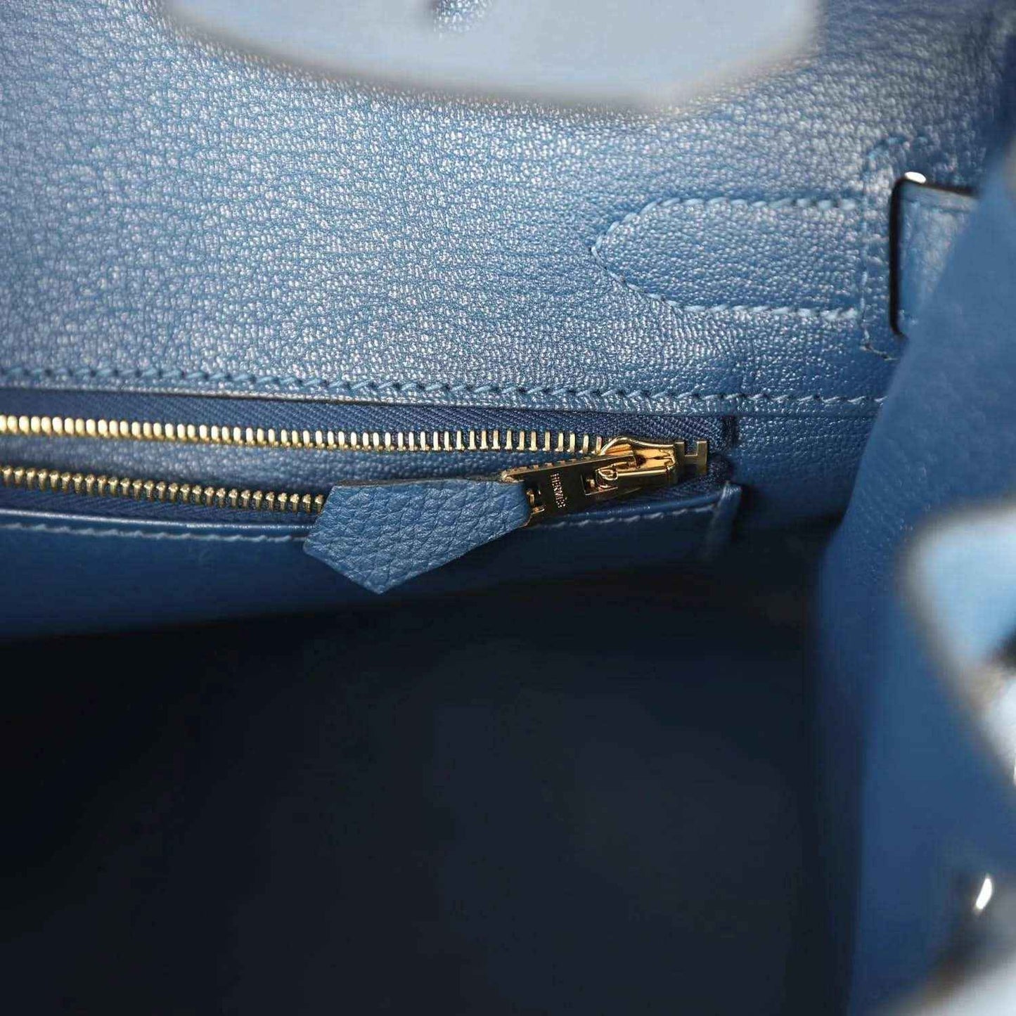 Hermes Birkin 30 blue Togo leather handbag close-up of zipper trim and pocket
