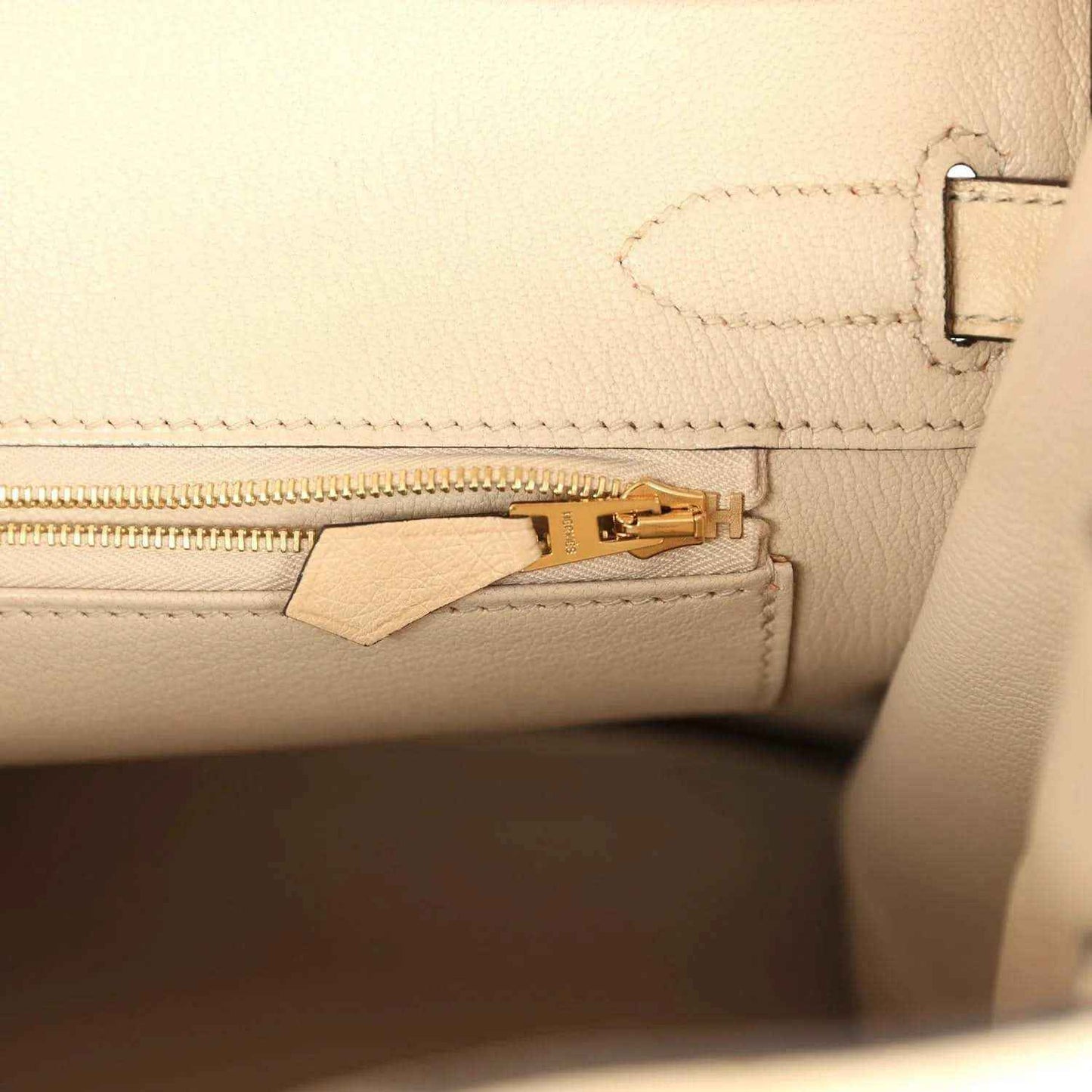 Hermes Birkin 30 zipper pocket close-up with gold-toned zipper pull and leather tab