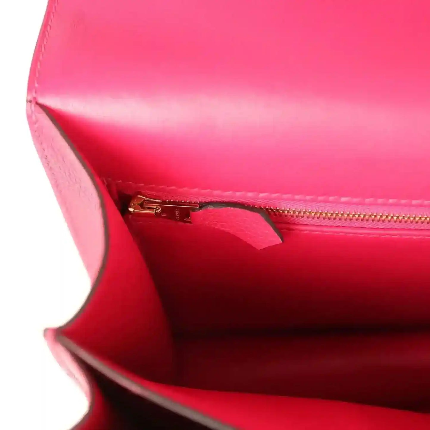 Red leather handbag interior with zipper pocket and gold-tone zipper pull