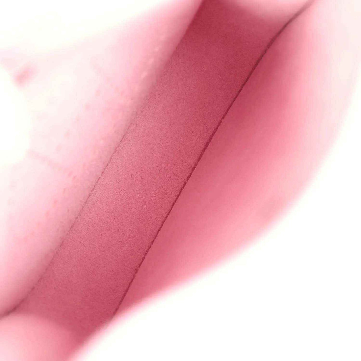 Mauve-pink leather crossbody bag close-up of interior lining and side seam