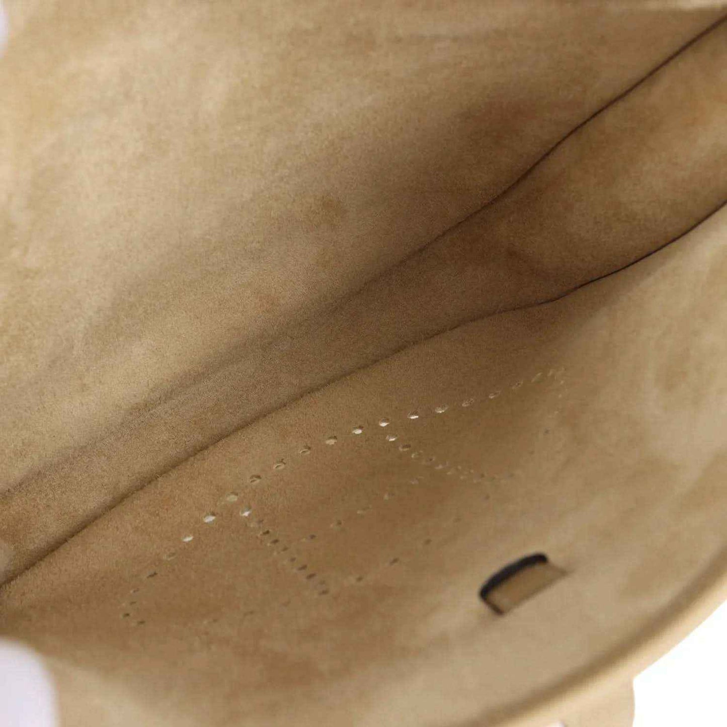 Tan leather bag interior with suede-like lining and small stitched pocket opening