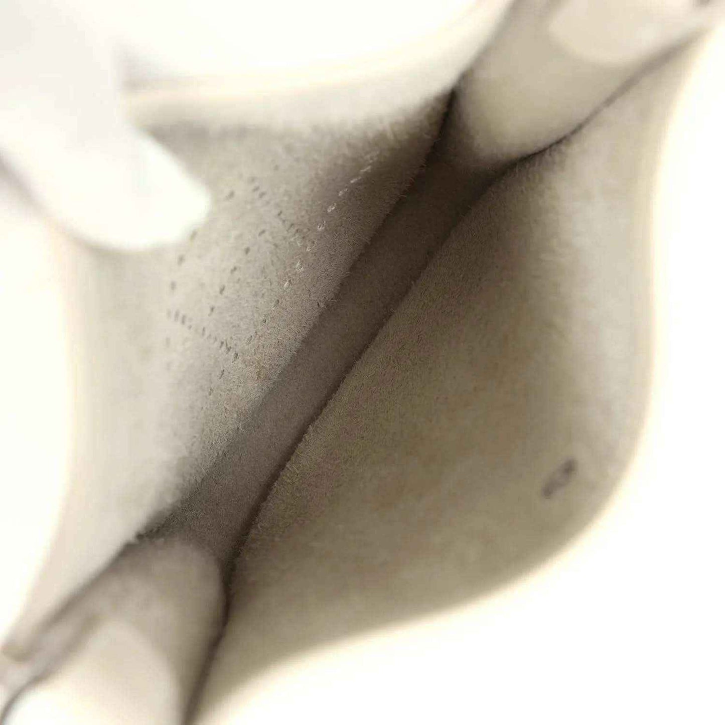 Light cream leather bag interior with smooth lining and small pocket