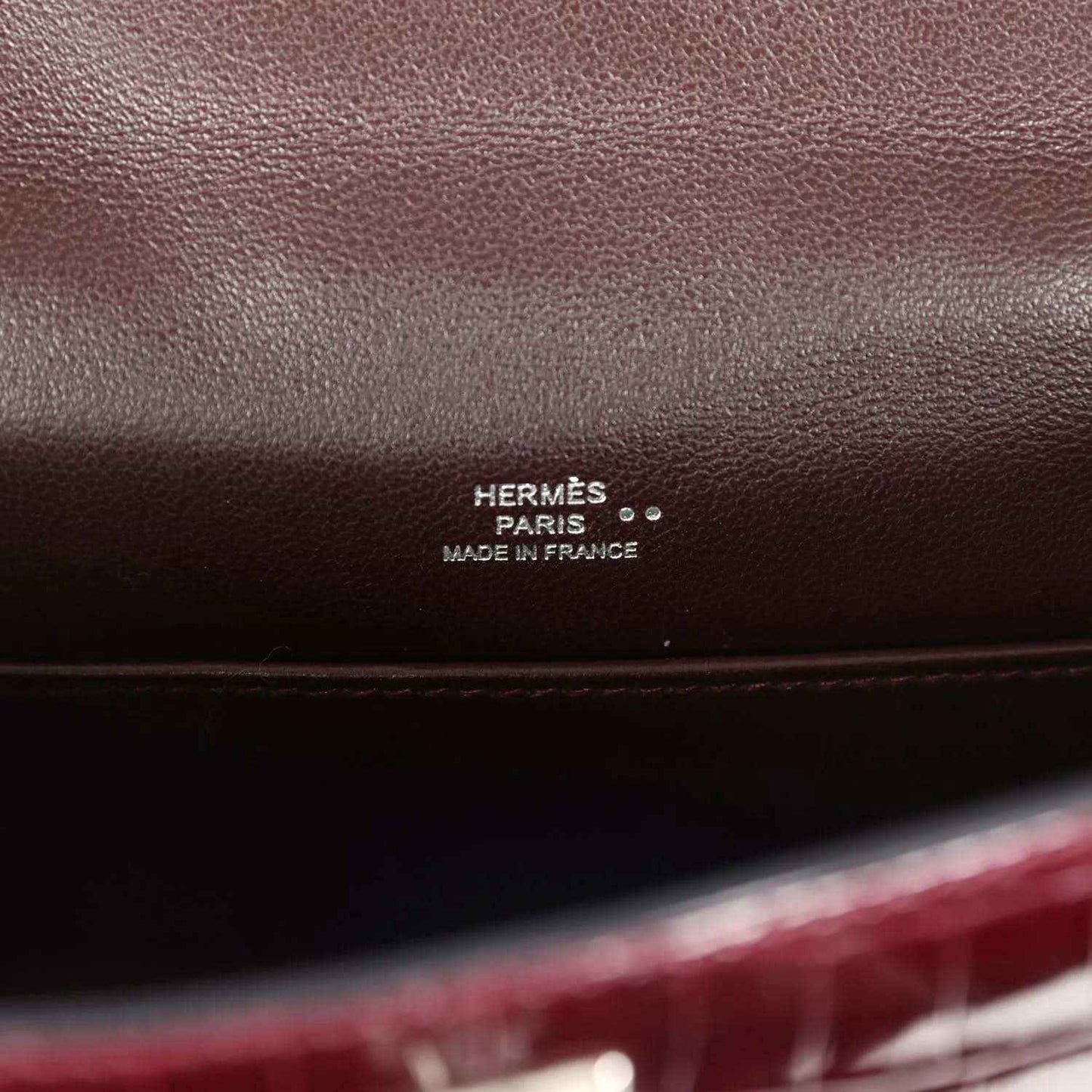 Hermès Paris stamp on burgundy handbag interior leather lining