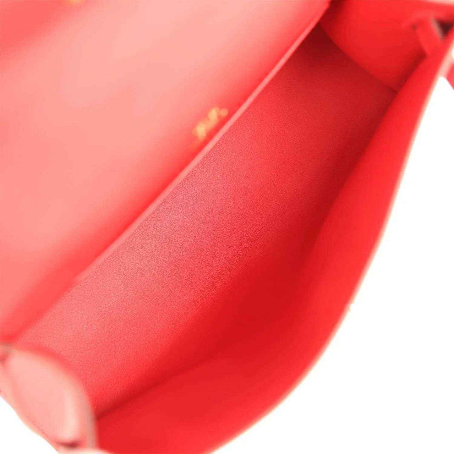 Red leather interior of pochette with visible stitching and inner pocket