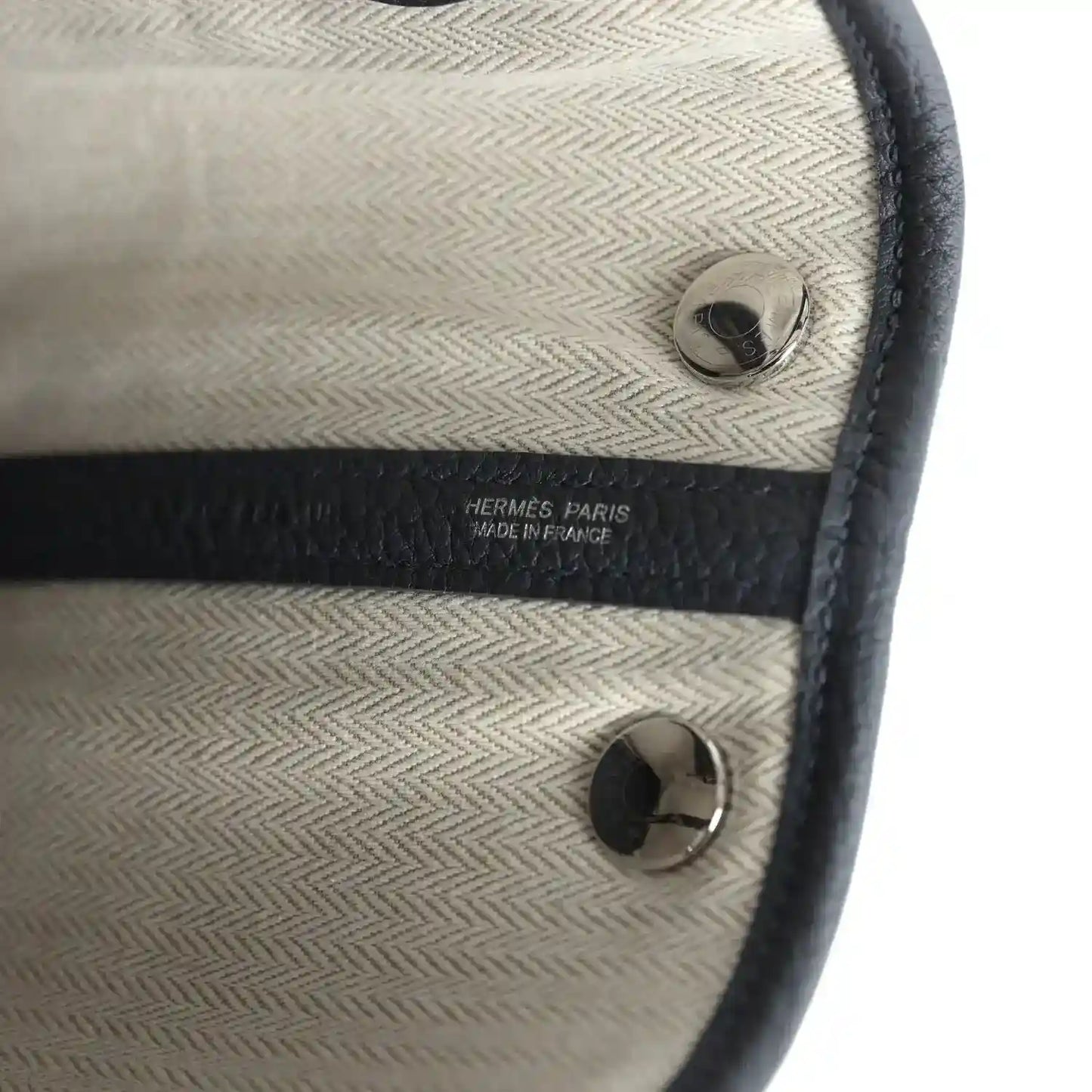 Cream fabric lining with dark trim, round hardware, and Hermes Paris label