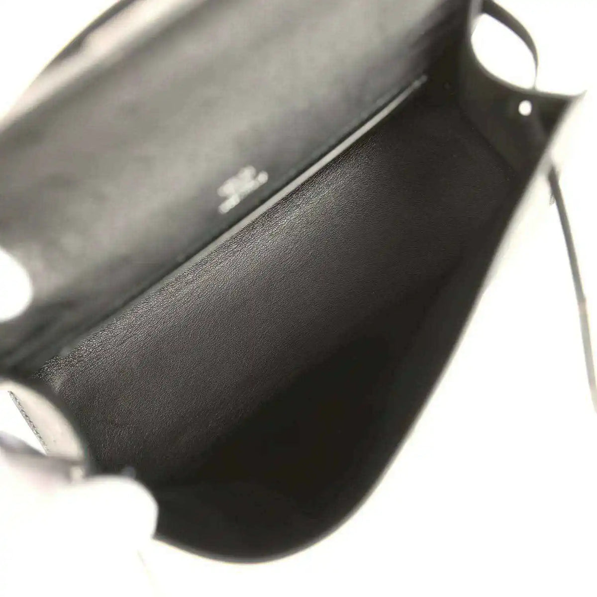Leather clutch interior view with side hardware and stitching