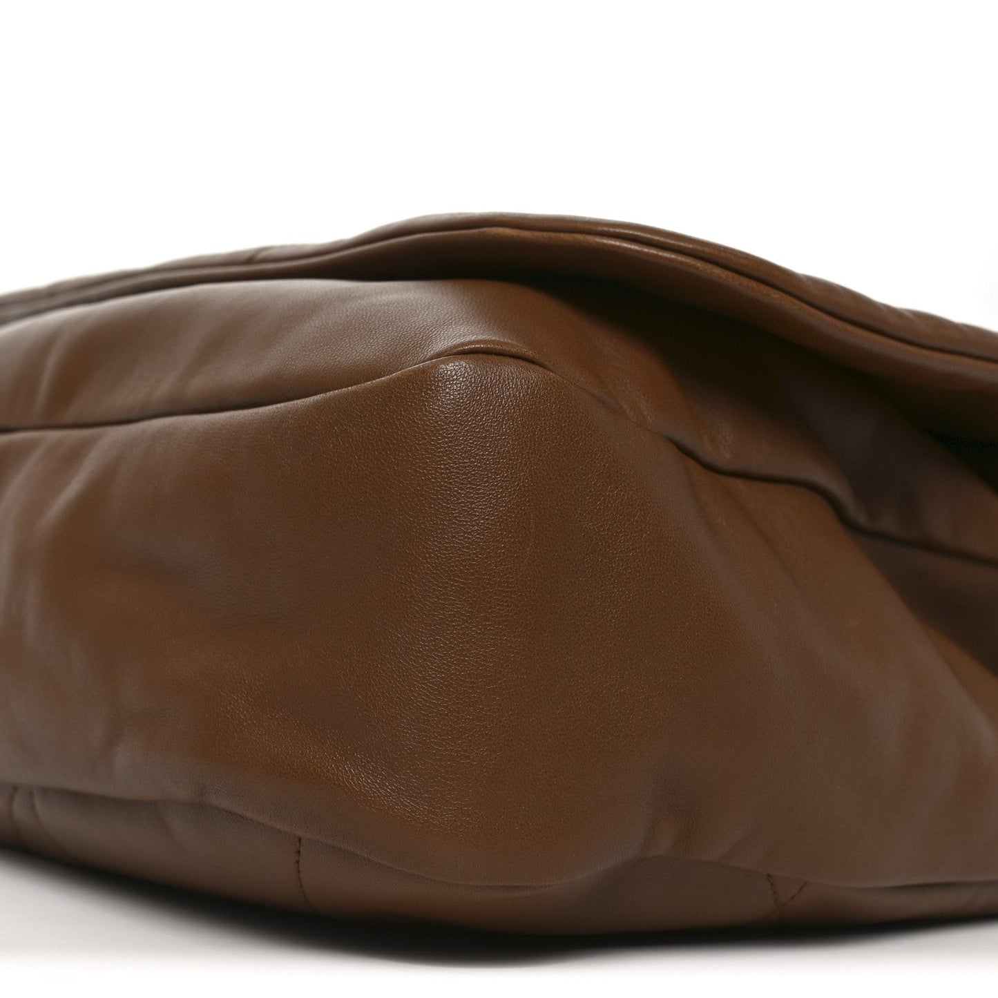 Close-up of lambskin shoulder bag side with smooth leather grain, light brown