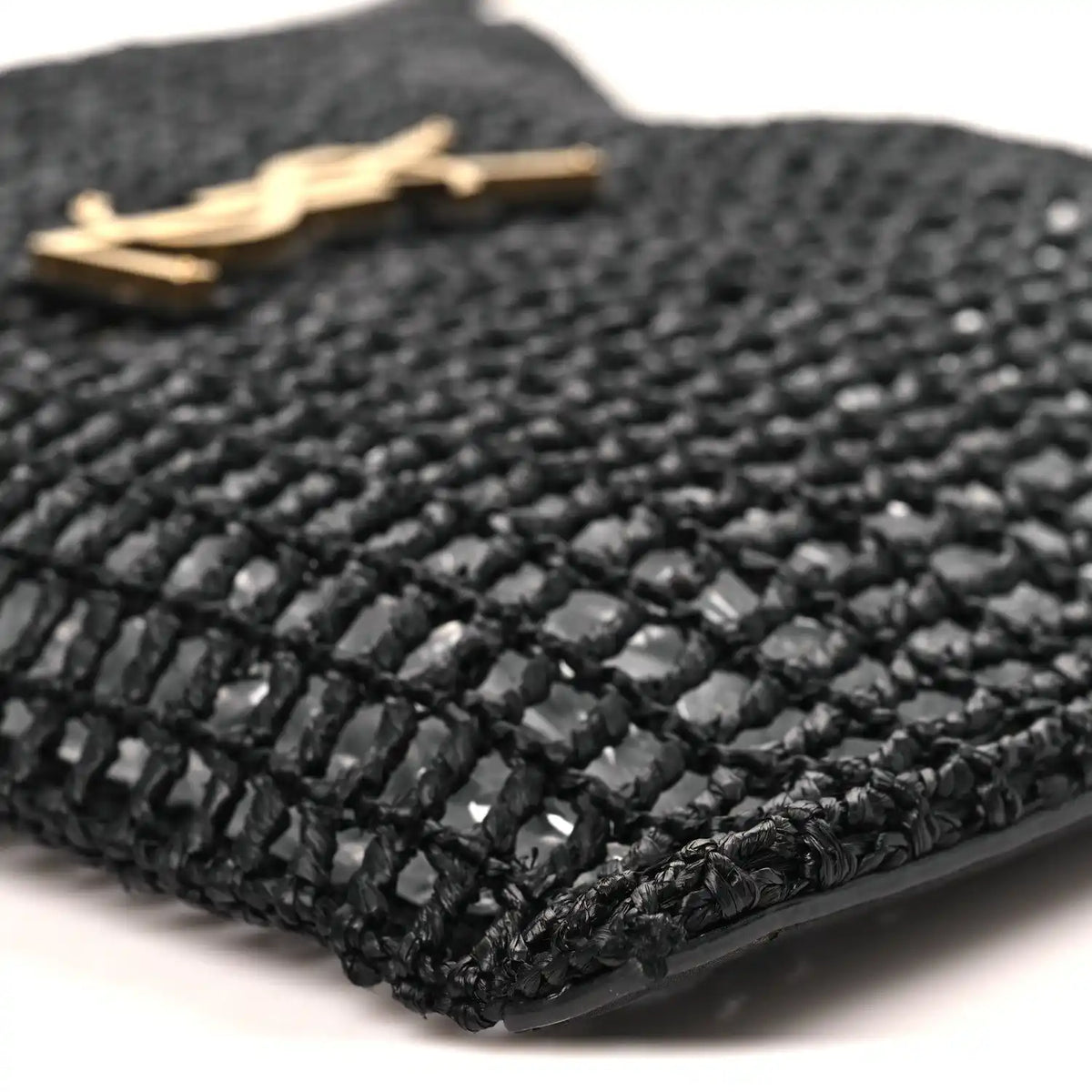 Black netted raffia weave with gold hardware on shoulder bag