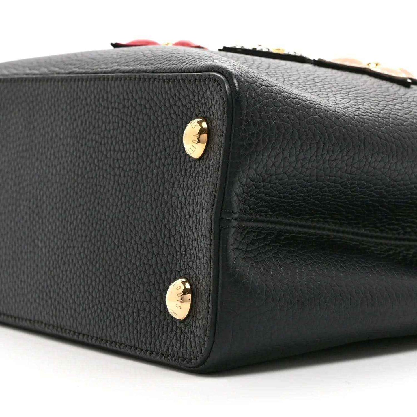 Black Louis Vuitton handbag side with gold stud accents and pebbled leather finish
