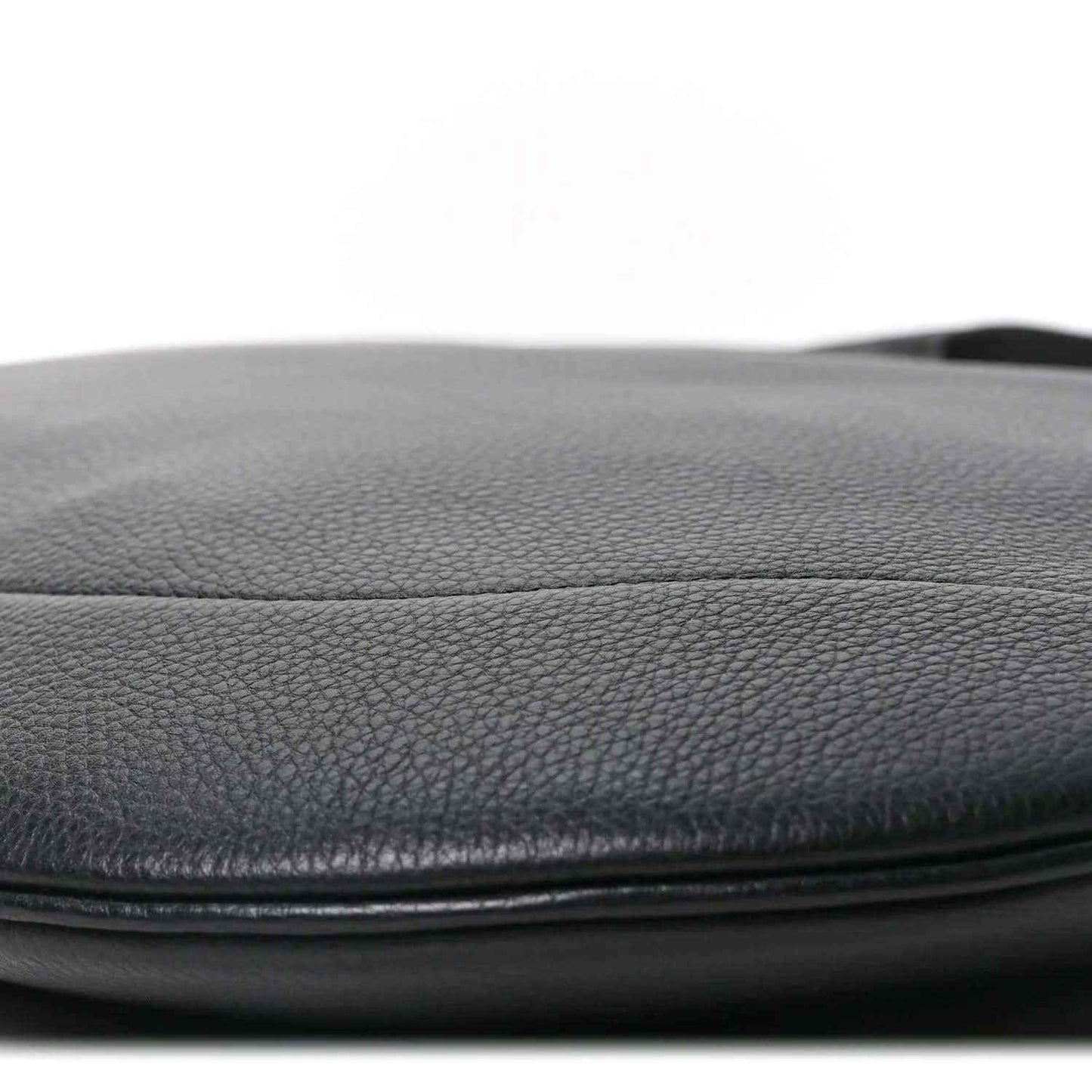 Black grained leather bag edge with smooth pebble texture