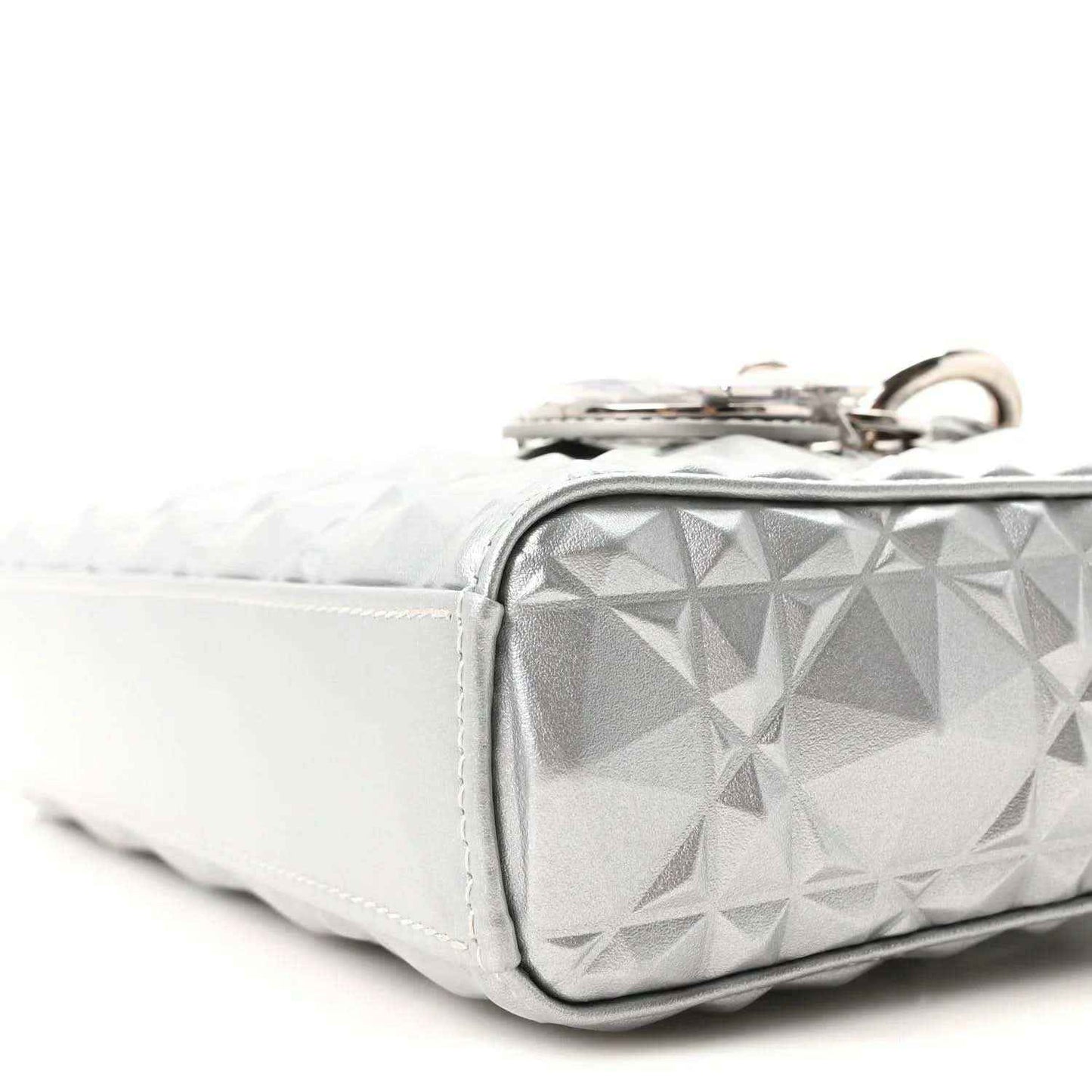 Small metallic silver handbag with geometric canage texture and metal top ring hardware.